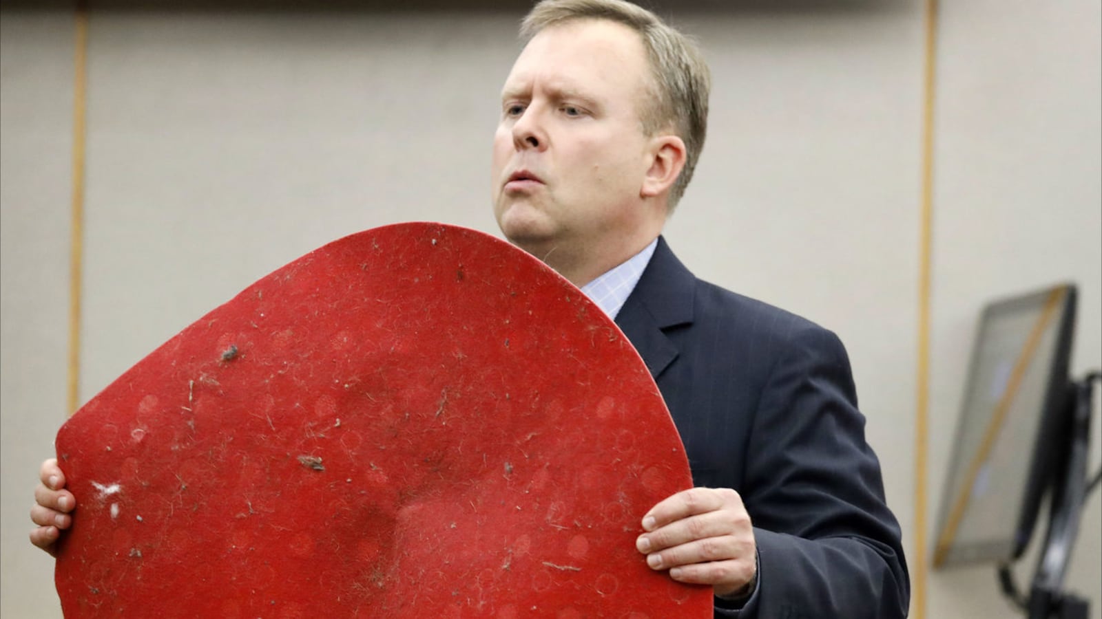 Prosecutor Jason Hermus shows jurors the red doormat Botham Jean had outside his apartment the night of Sept. 6, 2018, when he was killed in his home by his neighbor, Amber Guyger. Guyger, who is charged with murder, was a Dallas police officer.