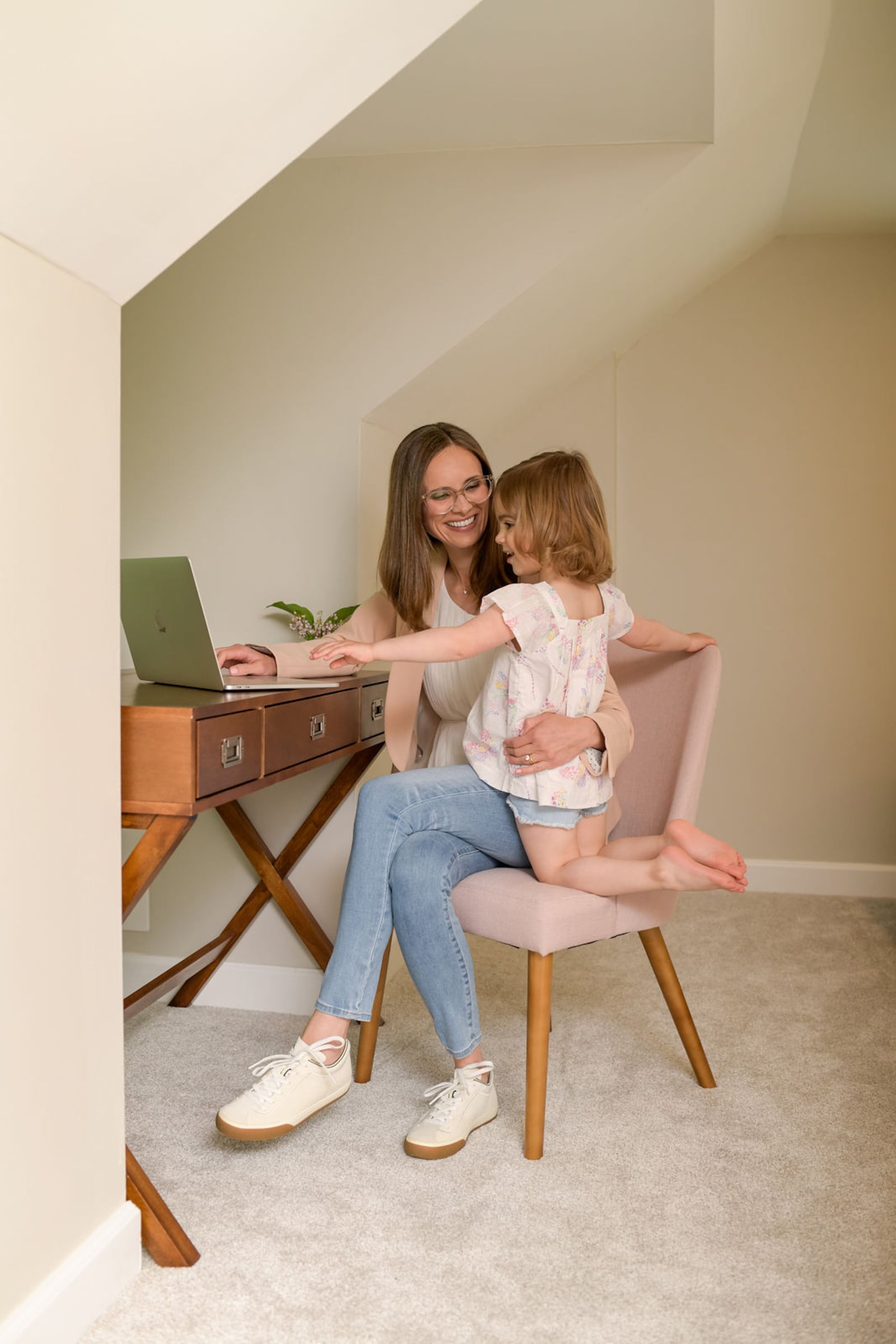 Kallile working in her home office with older daughter Lucy, now 4. Kallile said she is grateful that she can pursue her dream of a business with her daughters at her side.