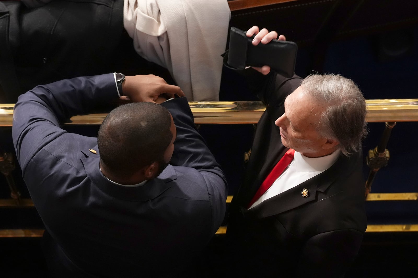 Rep. Byron Donalds, R-Fla., left, and Rep. Andy Biggs, R-Ariz., speak as the House of Representatives meets to elect a speaker and convene the new 119th Congress at the Capitol in Washington, Friday, Jan. 3, 2025. (AP Photo/Jacquelyn Martin)