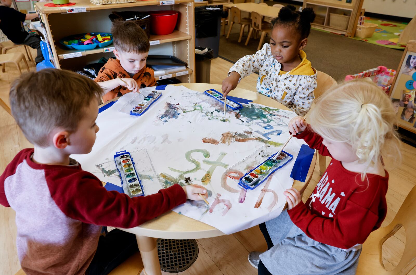 Left to right: Stephen K., Casen B., Jazlynn J. and Louise G., students in the pre-k class at Mini University, a child development center on the Miami  University campus, work on a painting project Thursday, April 6, 2023 in Oxford. NICK GRAHAM/STAFF