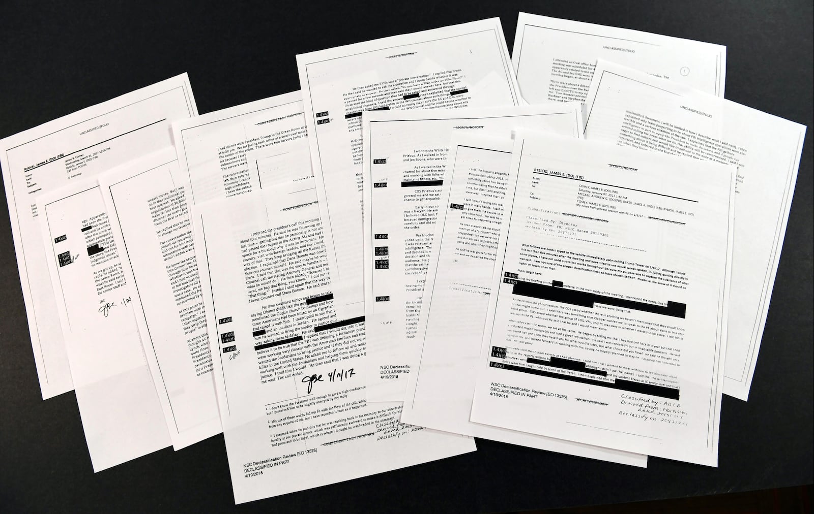 Copies of the memos written by former FBI Director James Comey are photographed in Washington, Thursday, April 19, 2018. President Donald Trump told former FBI Director James Comey that he had serious concerns about the judgment of his first national security adviser, Michael Flynn, according to memos maintained by Comey and obtained by The Associated Press. The 15 pages of documents contain new details about a series of interactions that Comey had with Trump in the weeks before his May 2017 firing. Those encounters include a White House dinner at which Comey says Trump asked him for his loyalty. (AP Photo/Susan Walsh)