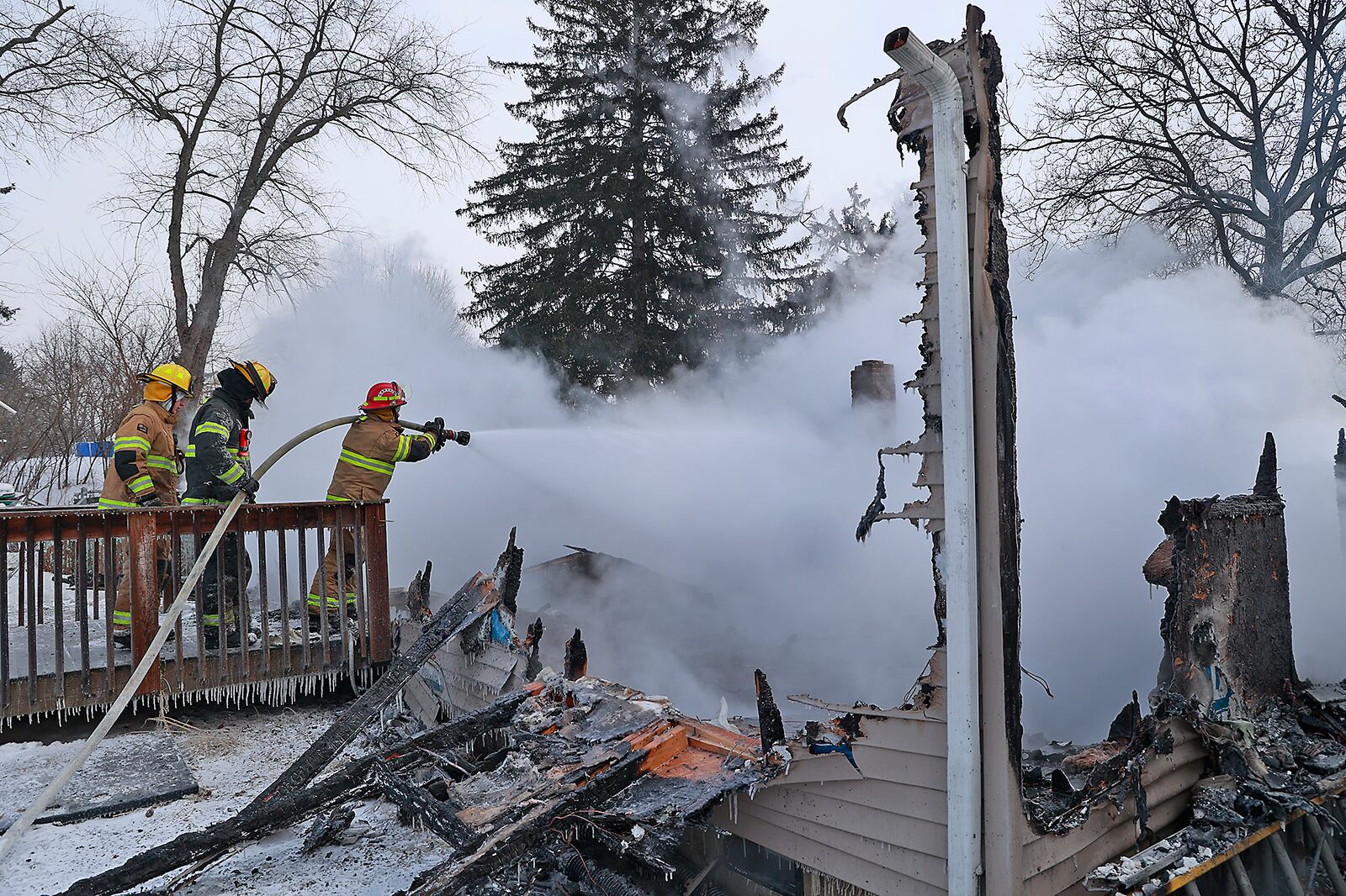 Firefighters battled the cold as well as a house fire on Scioto Street in Springfield Township Friday, Dec. 23, 2022. The City of Springfield Fire Division responded to provide mutual aid for the fire that completely destroyed the home. One person was transported to the hospital from the scene. The sub zero caused equipment from the township and city to freeze up at the scene. BILL LACKEY/STAFF