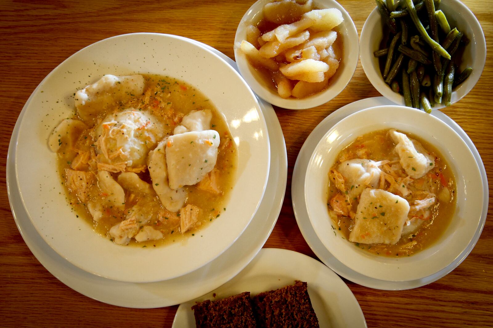 Dan Young, owner of Young's Jersey Dairy and the Golden Jersey Inn in Clark County, is incorporating some lower-calorie and smaller-portion options into his restaurant's menu. Two sizes of chicken and dumplings are available. On the left is an order that is approximately 600 calories and at right is a smaller order at approximately 350 calories. Both orders come with a selection of side dishes. LISA POWELL / STAFF