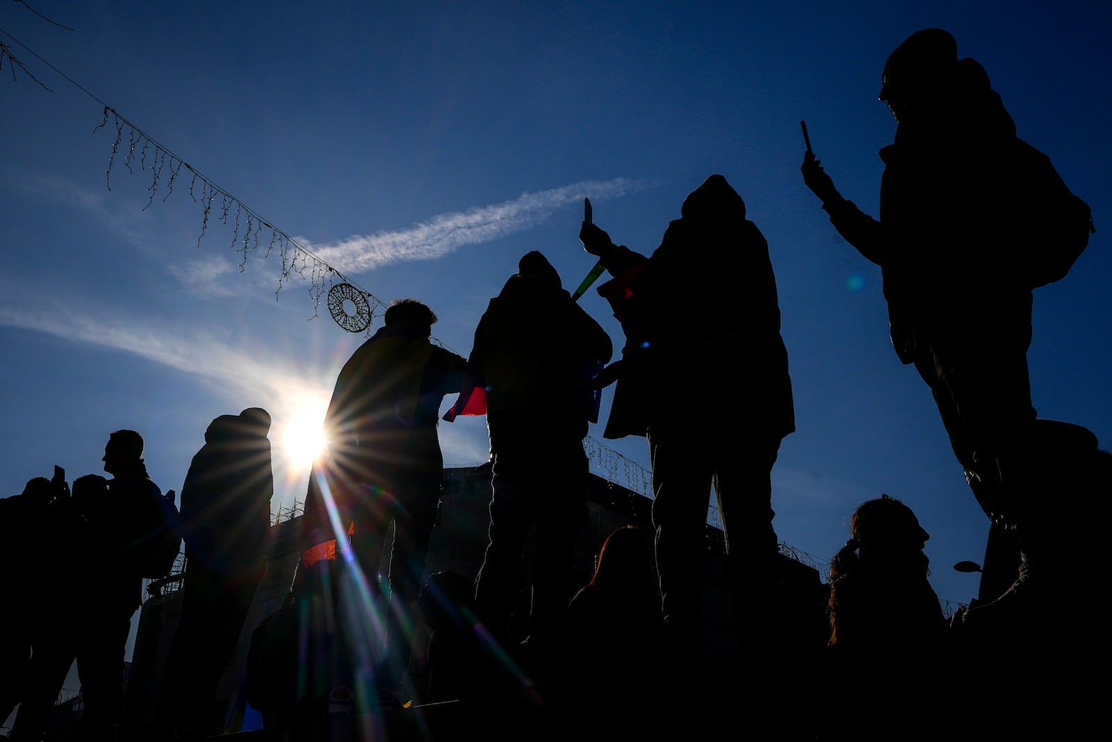 Protesters film with their mobile phones during a rally organized by the right wing Alliance for the Unity of Romanians (AUR), calling for free elections after Romania' s Constitutional Court annulled the first round of presidential elections last December, in Bucharest, Romania, Sunday, Jan. 12, 2025. (AP Photo/Vadim Ghirda)