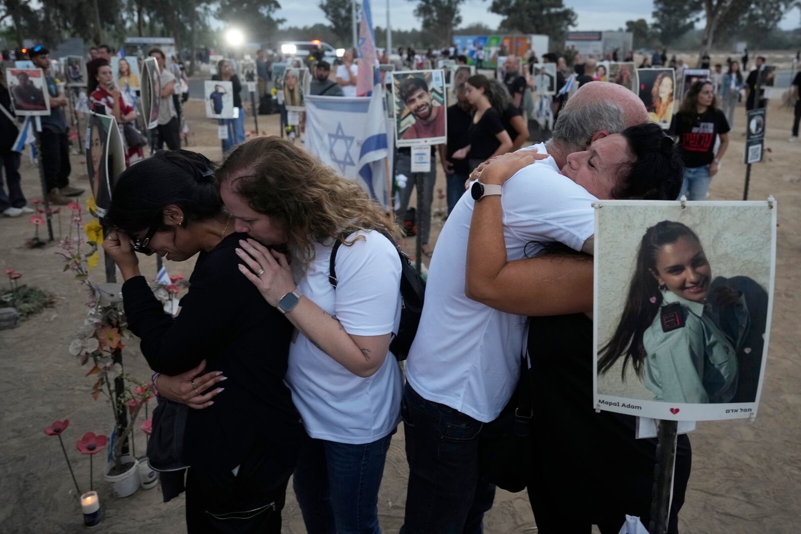 FILE - People visit the site of the Nova music festival, where hundreds of revelers were killed and abducted by Hamas and taken into Gaza, on the one-year anniversary of the attack, near Kibbutz Reim, southern Israel, Oct. 7, 2024. (AP Photo/Ariel Schalit, File)