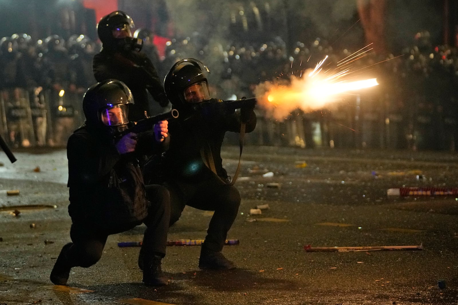 Police shoot tear gas towards demonstrators during a protest against the government's decision to suspend negotiations on joining the European Union in Tbilisi, Georgia, early Wednesday, Dec. 4, 2024. (AP Photo/Pavel Bednyakov)