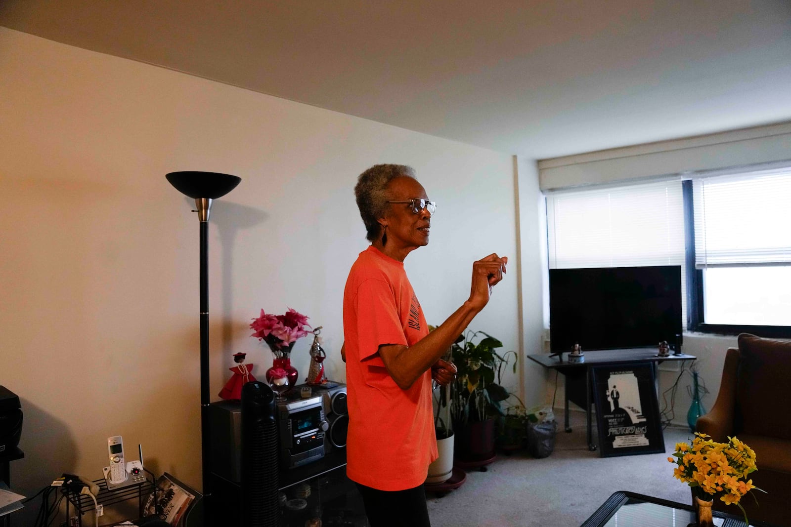 Bernadine Gibson, 82, wears an orange shirt as she talks about looking forward to renovations to the building her family has lived in for 27 years, Monday, Nov. 18, 2024, in Chicago. (AP Photo/Erin Hooley)