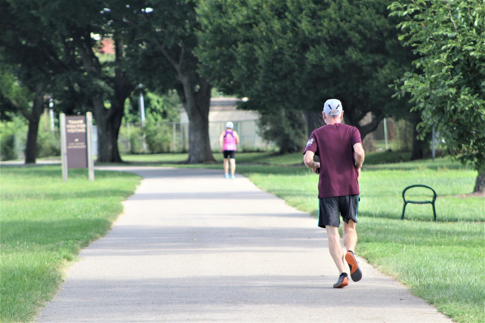 People walk and run along the river, north of downtown Dayton. CORNELIUS FROLIK / STAFF