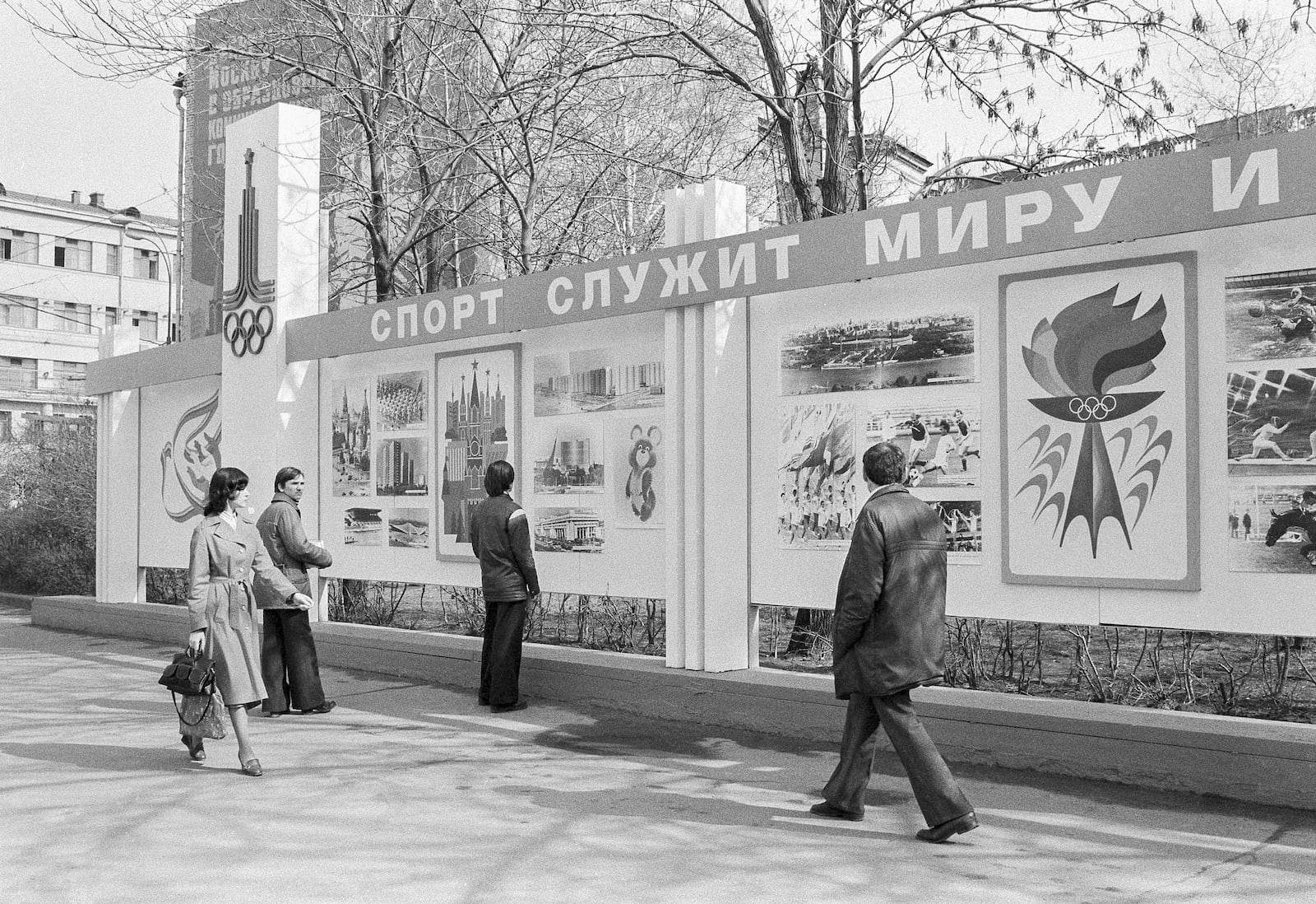 FILE - Passersby examine the new Olympic billboard reading, "Sport Serves Peace," erected after the United States announced it was boycotting the games in Moscow on April 23, 1980. (AP Photo/Yurchenko, File)