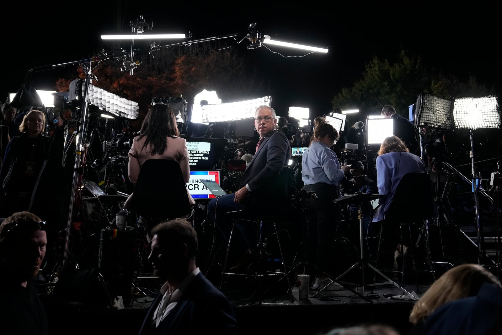 Members of the media work ahead of an election night campaign watch party for Democratic presidential nominee Vice President Kamala Harris, Tuesday, Nov. 5, 2024, on the campus of Howard University in Washington. (AP Photo/Ben Curtis)