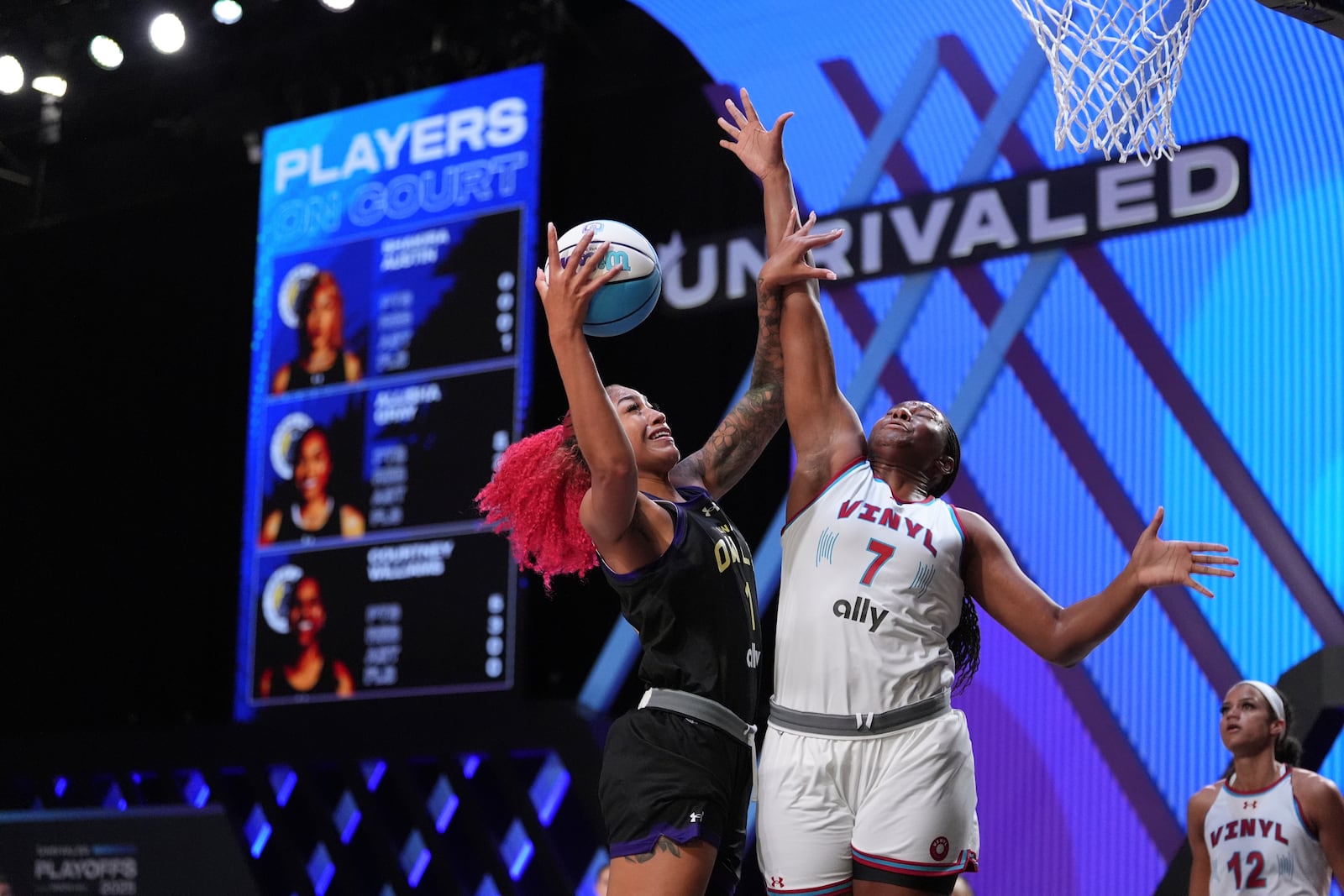 Lunar Owls forward Shakira Austin shoots defended by Vinyl forward Aliyah Boston in their Unrivaled 3-on-3 basketball semifinal, Sunday, March 16, 2025, in Medley, Fla. (AP Photo/Rebecca Blackwell)