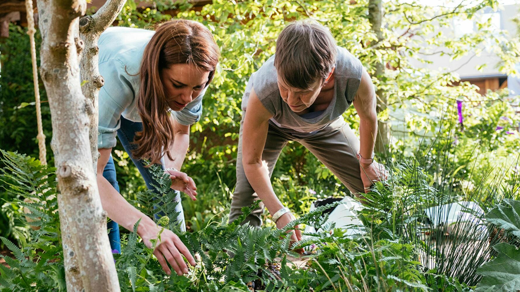 In this image made available on Sunday May 19, 2019 by Kensington Palace, Britain's Kate, Duchess of Cambridge and her son Prince Louis play in the ‘Bback to Nature’ garden at the RHS Chelsea Flower Show in London