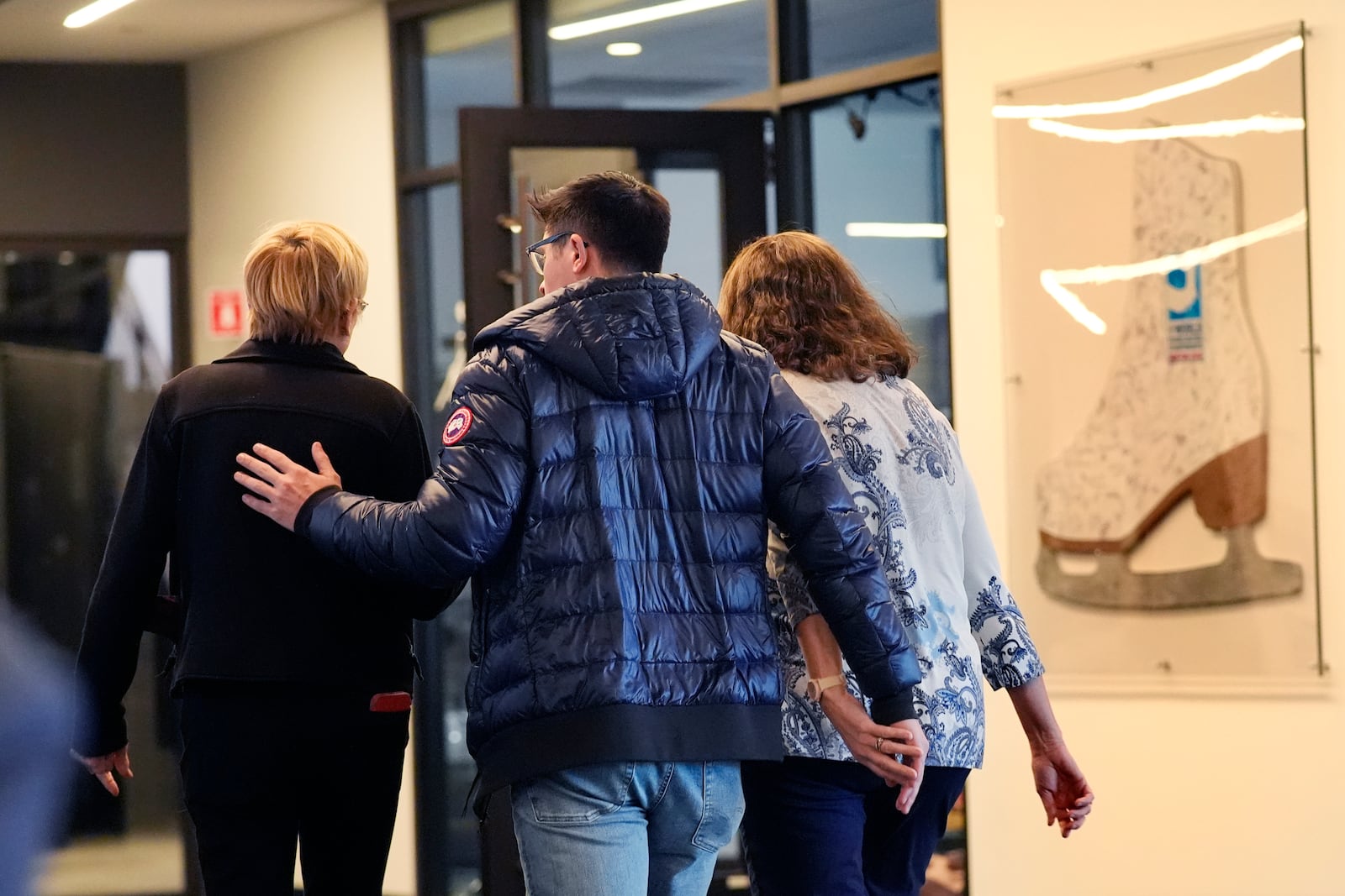 People associated with The Skating Club of Boston console each other, Thursday, Jan. 30, 2025, in Norwood, Mass. (AP Photo/Robert F. Bukaty)