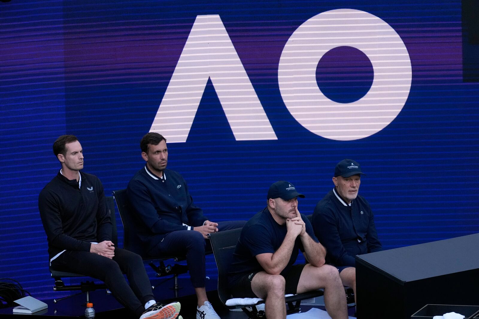 Andy Murray, left, coach of Novak Djokovic of Serbia watches his first round match against Nishesh Basavareddy of the U.S. at the Australian Open tennis championship in Melbourne, Australia, Monday, Jan. 13, 2025. (AP Photo/Asanka Brendon Ratnayake)