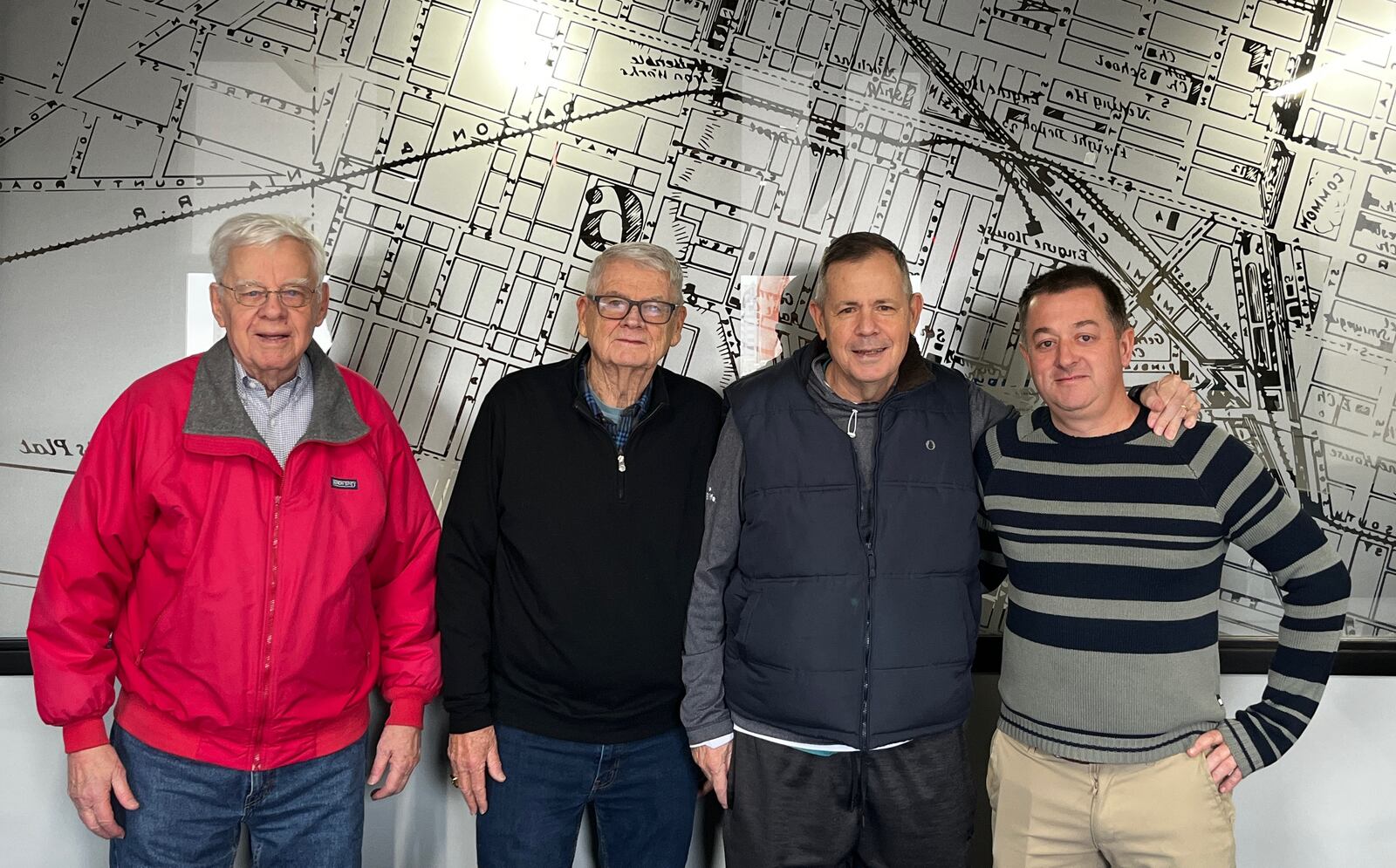 Dayton Flyers beat writers for the Dayton Daily News pose for a photo at the Dayton Daily News office in Dayton on Thursday, Jan. 23, 2025 (left to right): Bucky Albers; Hal McCoy; Doug Harris; and David Jablonski. Staff photo by Sarah Cavender