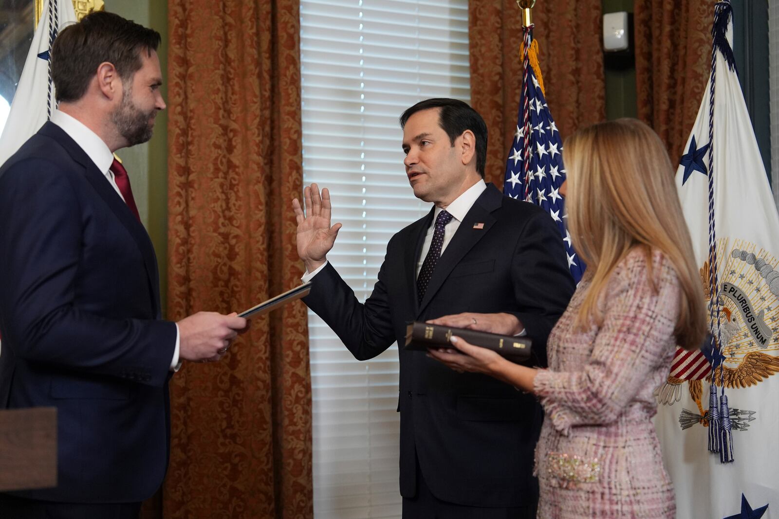 Secretary of State Marco Rubio is sworn by Vice President JD Vance in the Vice Presidential Ceremonial Office in the Eisenhower Executive Office Building on the White House campus, Tuesday, Jan. 21, 2025, in Washington, as his wife, Jeanette Rubio, looks on. (AP Photo/Evan Vucci)