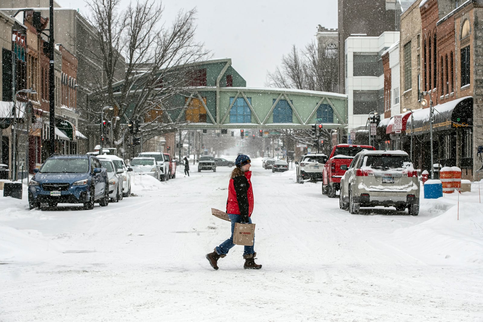 Pedestrians make their way across Dubuque Street in Iowa City, Iowa, Wednesday, Feb. 12, 2025. (Nick Rohlman/The Gazette via AP)