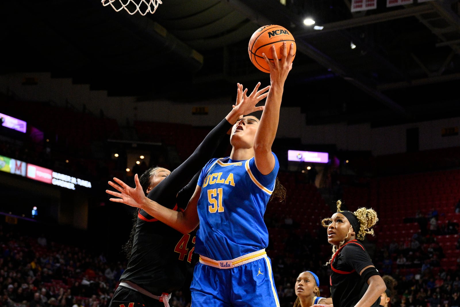 UCLA center Lauren Betts (51) goes to the basket against Maryland forward Amari DeBerry, left, during the first half of an NCAA college basketball game, Sunday, Jan. 26, 2025, in College Park, Md. (AP Photo/Nick Wass)