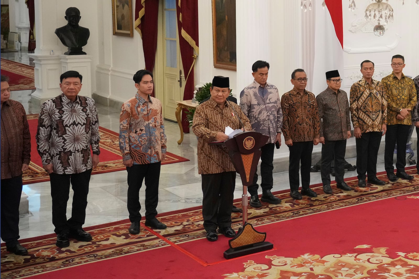 Indonesia's new President Prabowo Subianto, center, announces his cabinet lineup of newly-appointed ministers, at Merdeka Palace, in Jakarta, Indonesia, Sunday, Oct. 20, 2024. (AP Photo/Achmad Ibrahim)