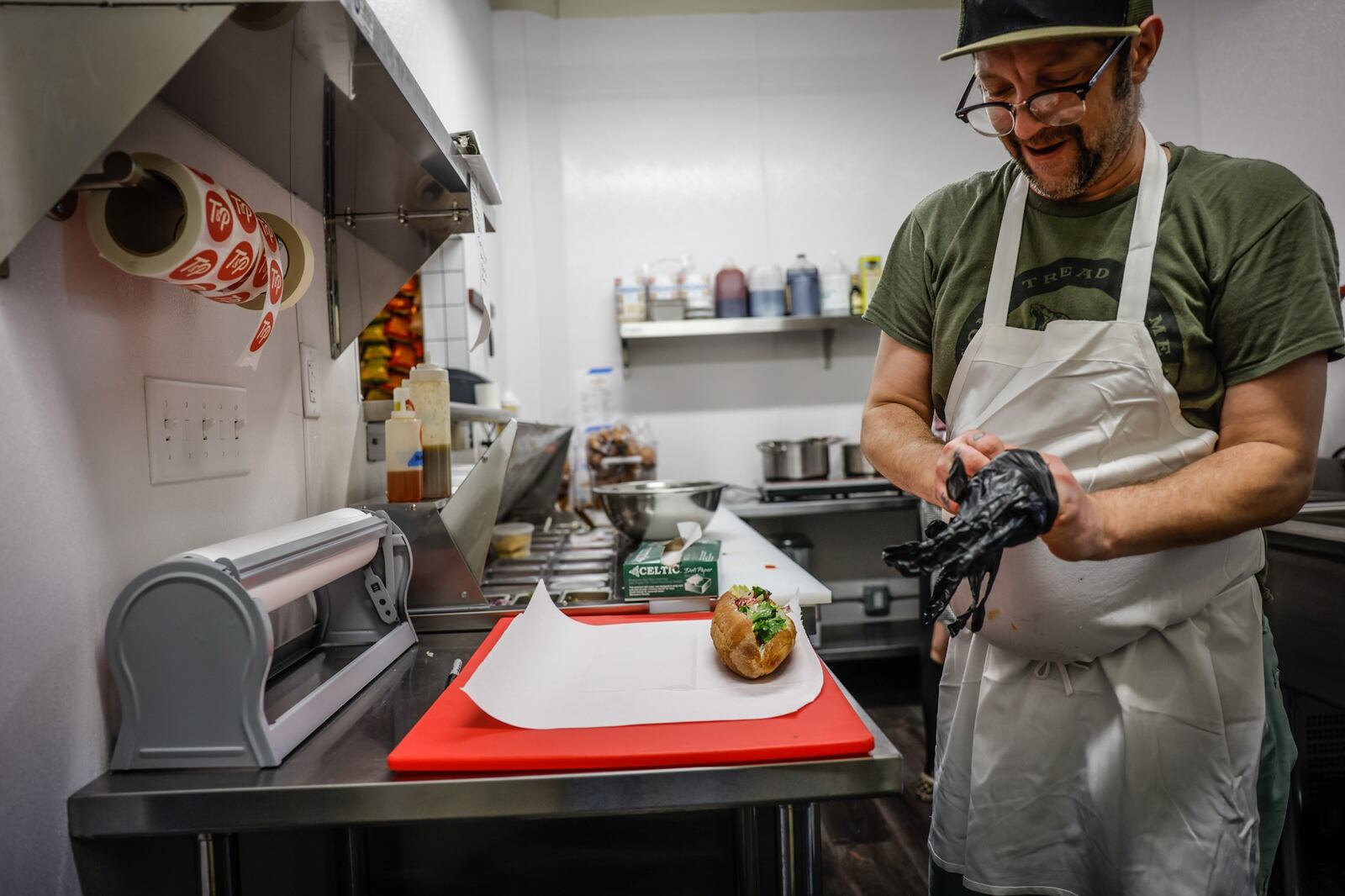 Tony & Pete's Groceries and Cold Cut and Sandwich Shop line cook, Andrew Straub makes a sandwich at the shop Thursday July 7,2022.