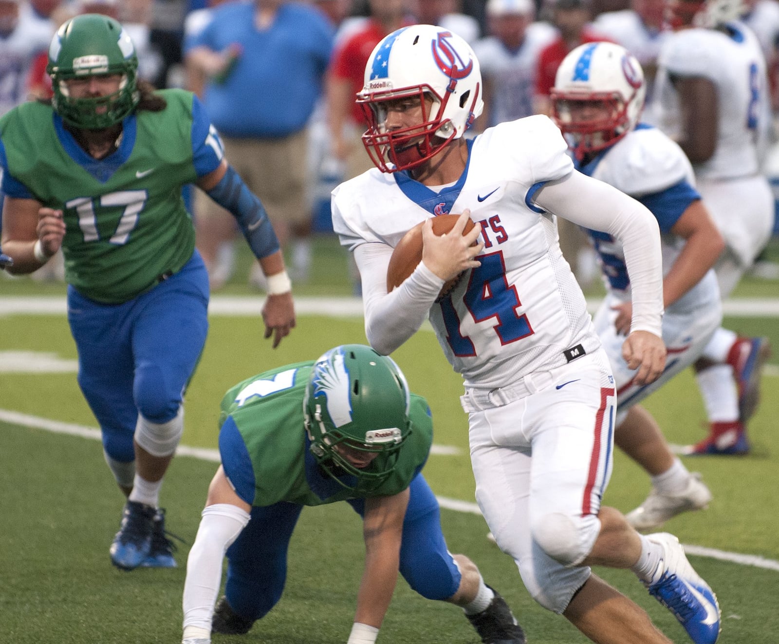 Carroll quarterback Trent Fox scrambles for yardage in the first half Friday night at Chaminade Julienne. Jeff Gilbert/CONTRIBUTED