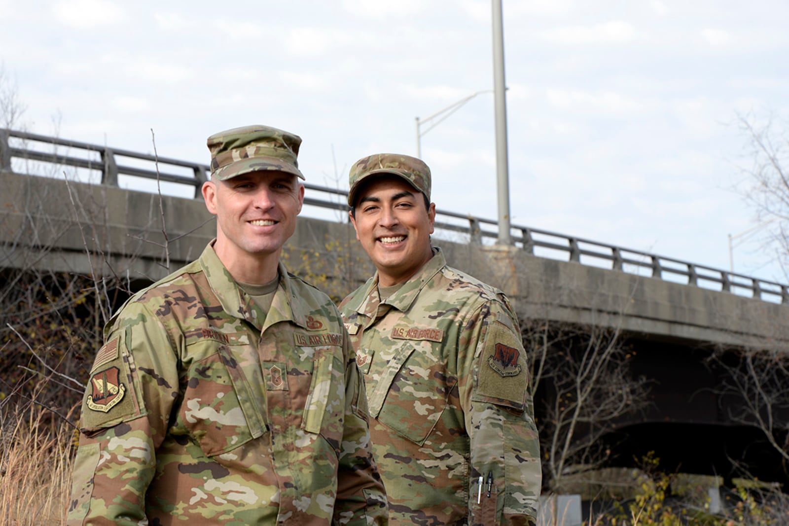 Senior Master Sgt. David Briden (left), Air Force Installation Contracting Center expeditionary operations manager, and Tech. Sgt. Anthony Staton, National Air and Space Intelligence Center, stand near the South Maple Avenue bridge in Fairborn Nov. 20 where they helped a distressed teen. U.S. AIR FORCE PHOTO/TY GREENLEES