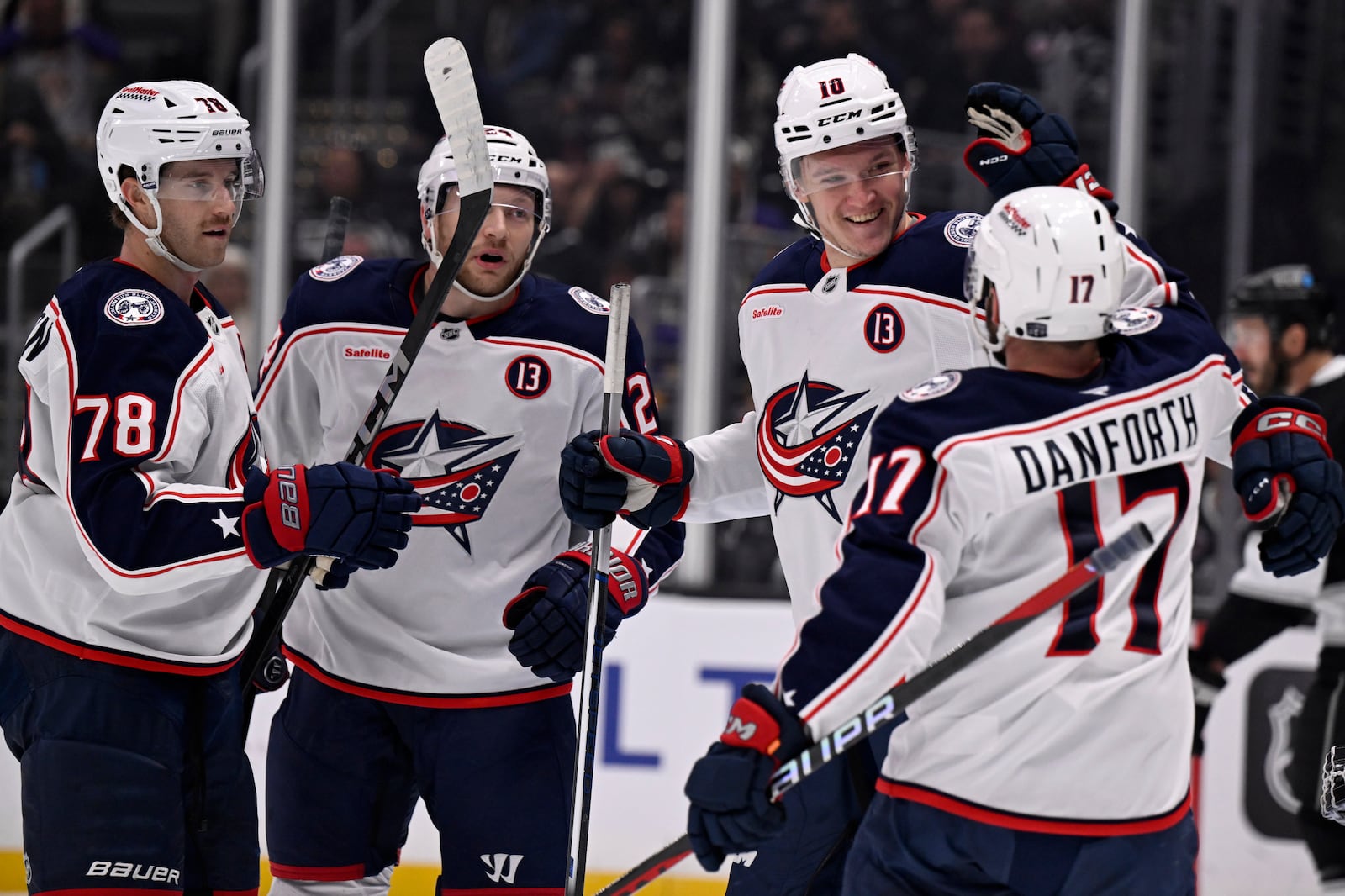 Columbus Blue Jackets left wing Dmitri Voronkov (10) celebrates after scoring against the Los Angeles Kings with right wing Justin Danforth (17), defenseman Damon Severson (78) and right wing Mathieu Olivier (24) during the first period of an NHL hockey game in Los Angeles, Saturday, Nov. 9, 2024. (AP Photo/Alex Gallardo)