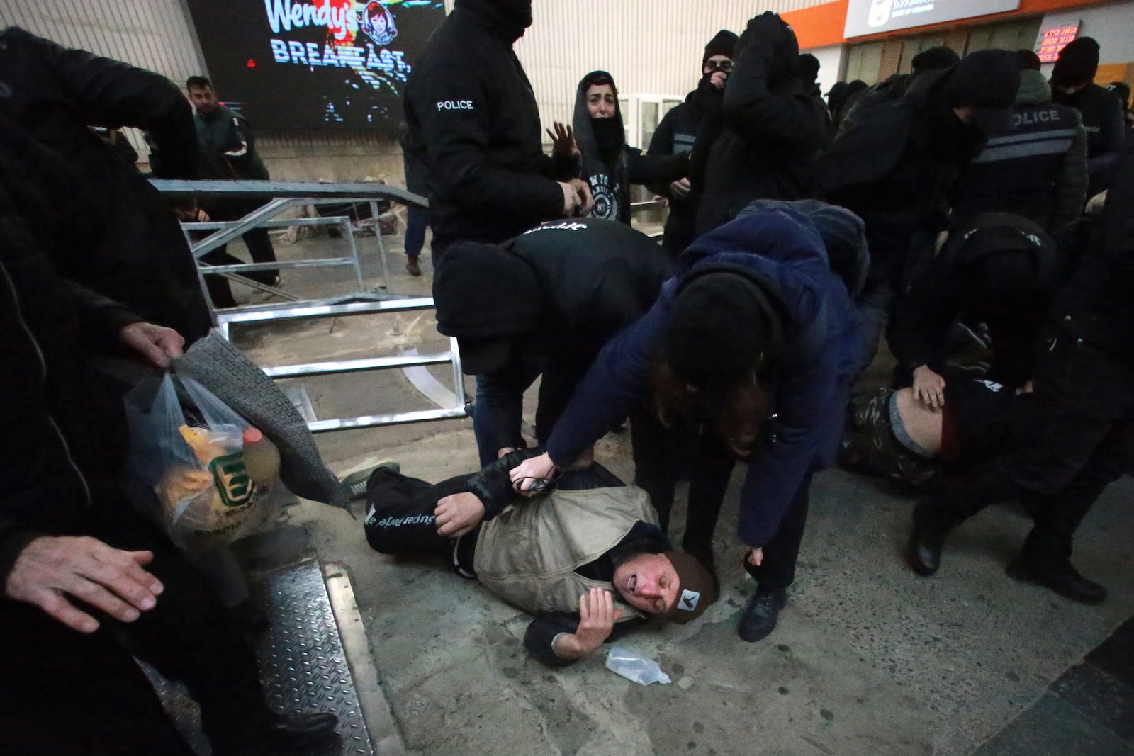 Police officers detain demonstrators at a subway station during a rally against the government's decision to suspend negotiations on joining the European Union for four years in Tbilisi, Georgia, Monday, Dec. 2, 2024. (AP Photo/Zurab Tsertsvadze)