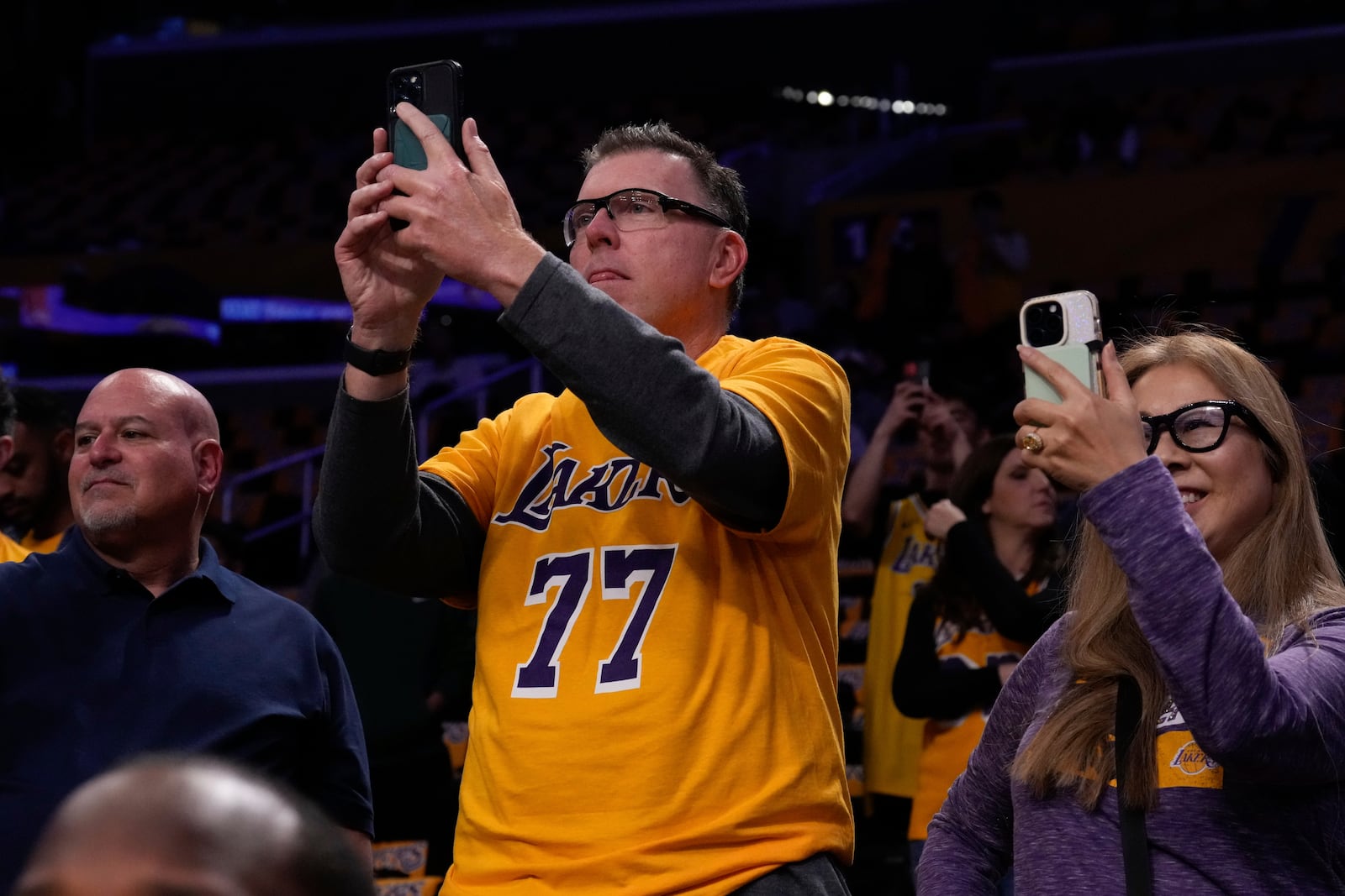 A fan wears shirt with number of Los Angeles Lakers guard Luka Doncic as he watches him warm up before an NBA basketball game against the Utah Jazz, Monday, Feb. 10, 2025, in Los Angeles. (AP Photo/Mark J. Terrill)