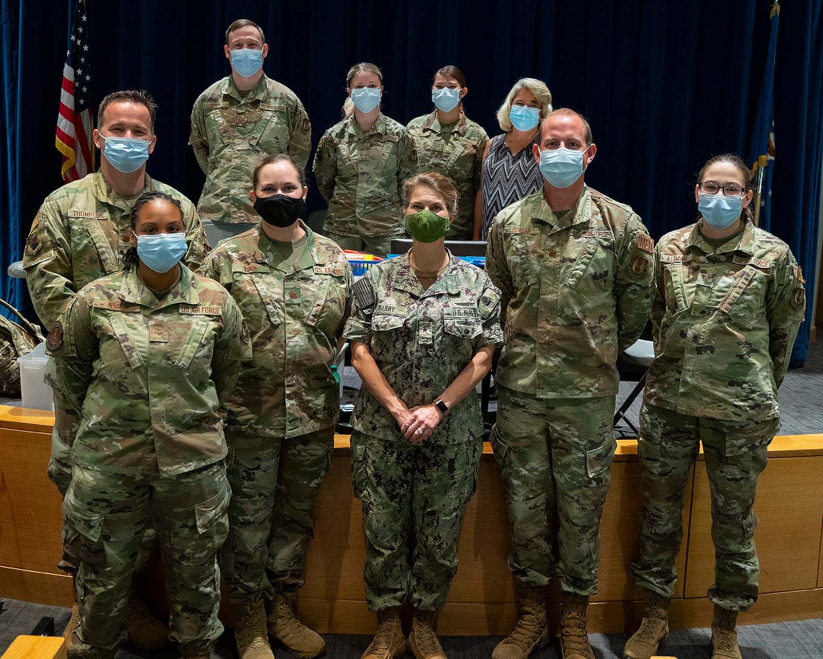 Rear Adm. Kristen Fabry (center), Defense Logistics Agency Land and Maritime commander, poses Oct. 1 with a group of 88th Medical Group Airmen during a visit to Wright-Patterson Medical Center. The Airmen were part of a team that traveled to Columbus earlier this year to administer COVID-19 vaccines to DLA members in Fabry’s command, and she wanted to personally thank them. U.S. AIR FORCE PHOTO/R.J. ORIEZ