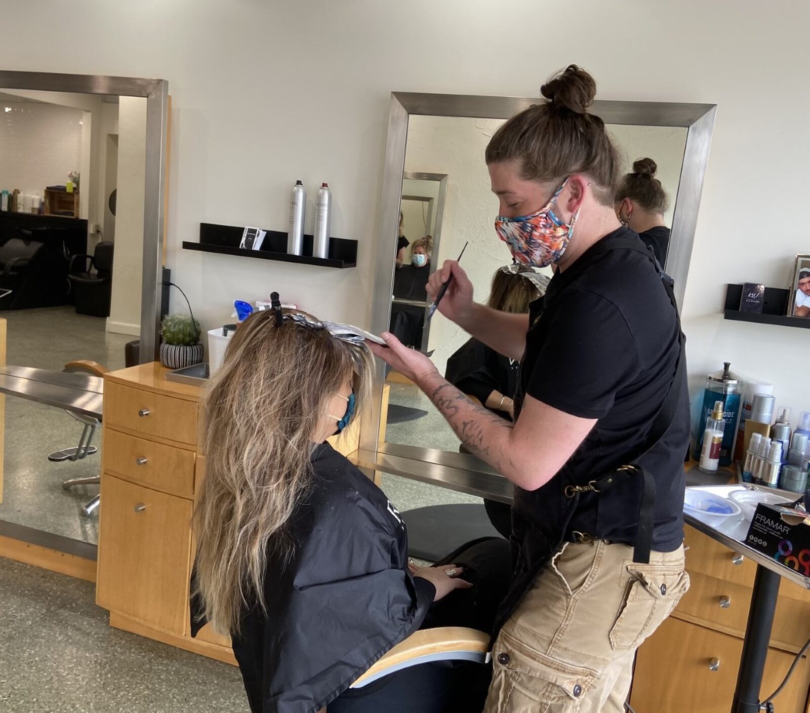 Kyle Williams style customer Jennifer Snow-Marshall’s hair at Bentley’s Salon in Fairborn on Friday. It was the first time in two months that salons and barbershops were allowed to open as part of the next phase of the governor s gradual re-opening of nonessential businesses.