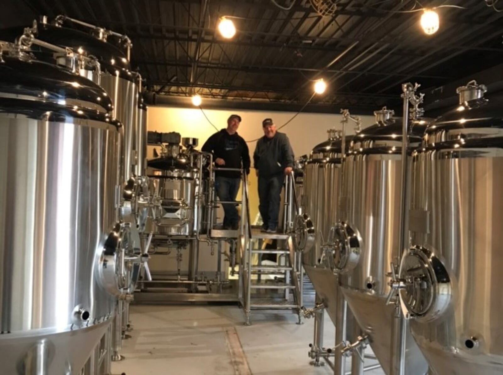 Southern Ohio Brewing founders Patrick Howard, left, and James Williams took delivery this week on the brewing equipment that will produce beer at their new craft brewery on Factory Road in Beavercreek.