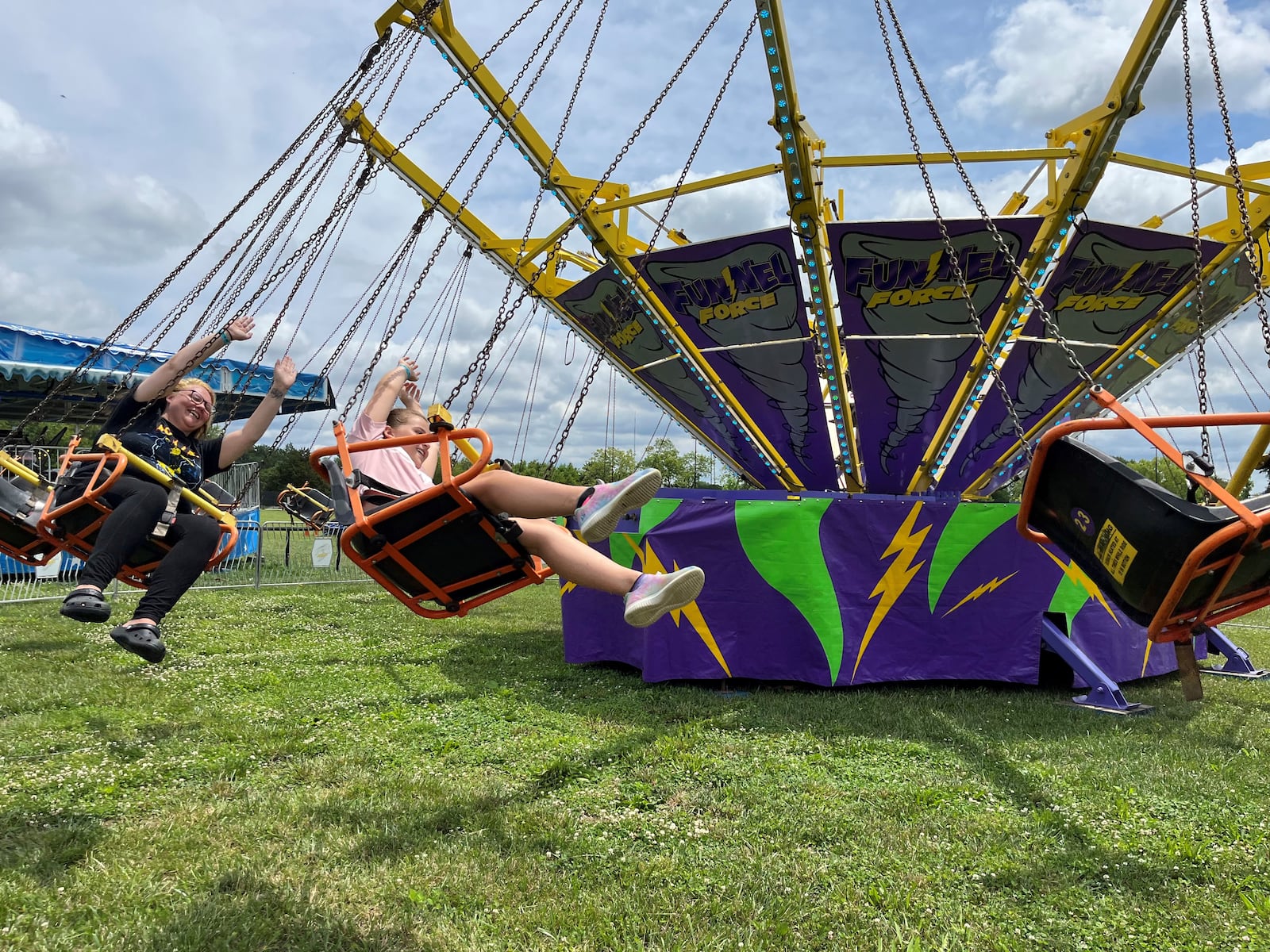 Shelbi Reffitt, 32, of Miamisburg, enjoys an amusement ride with her 11-year-old daughter, Ava Rich, at the Montgomery County Fair on Sunday, July 9, 2023. CORNELIUS FROLIK / STAFF