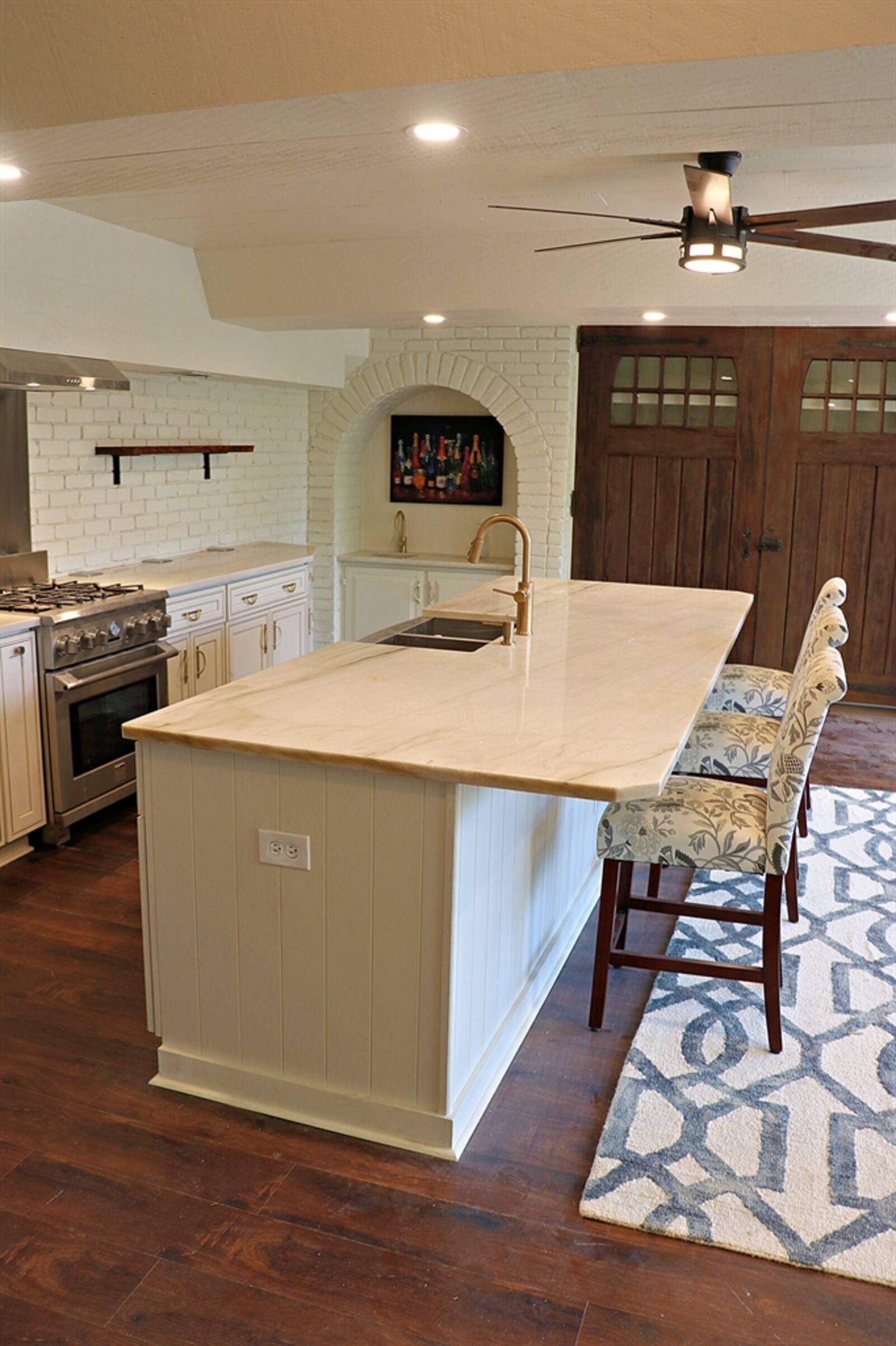 The gourmet-style kitchen features high-end appliances, granite counters and an oversized center island with seating.