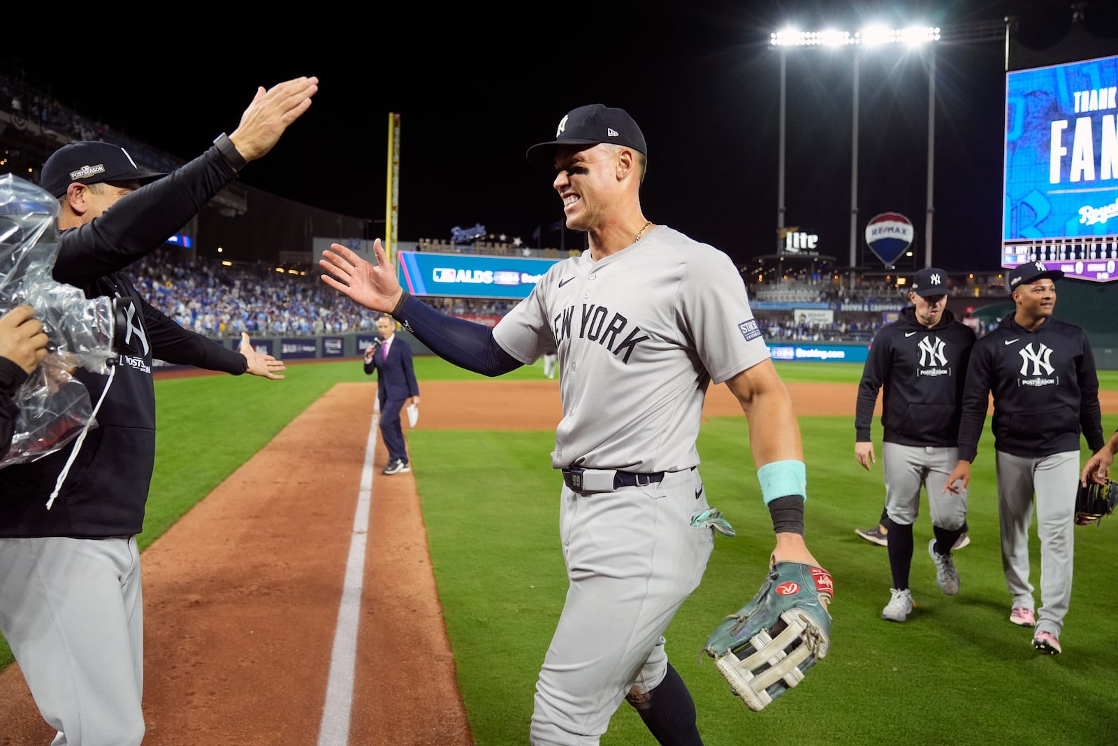 New York Yankees' Aaron Judge celebrates a 3-1 victory over the Kansas City Royals in Game 4 of an American League Division baseball playoff series Thursday, Oct. 10, 2024, in Kansas City, Mo. (AP Photo/Charlie Riedel)