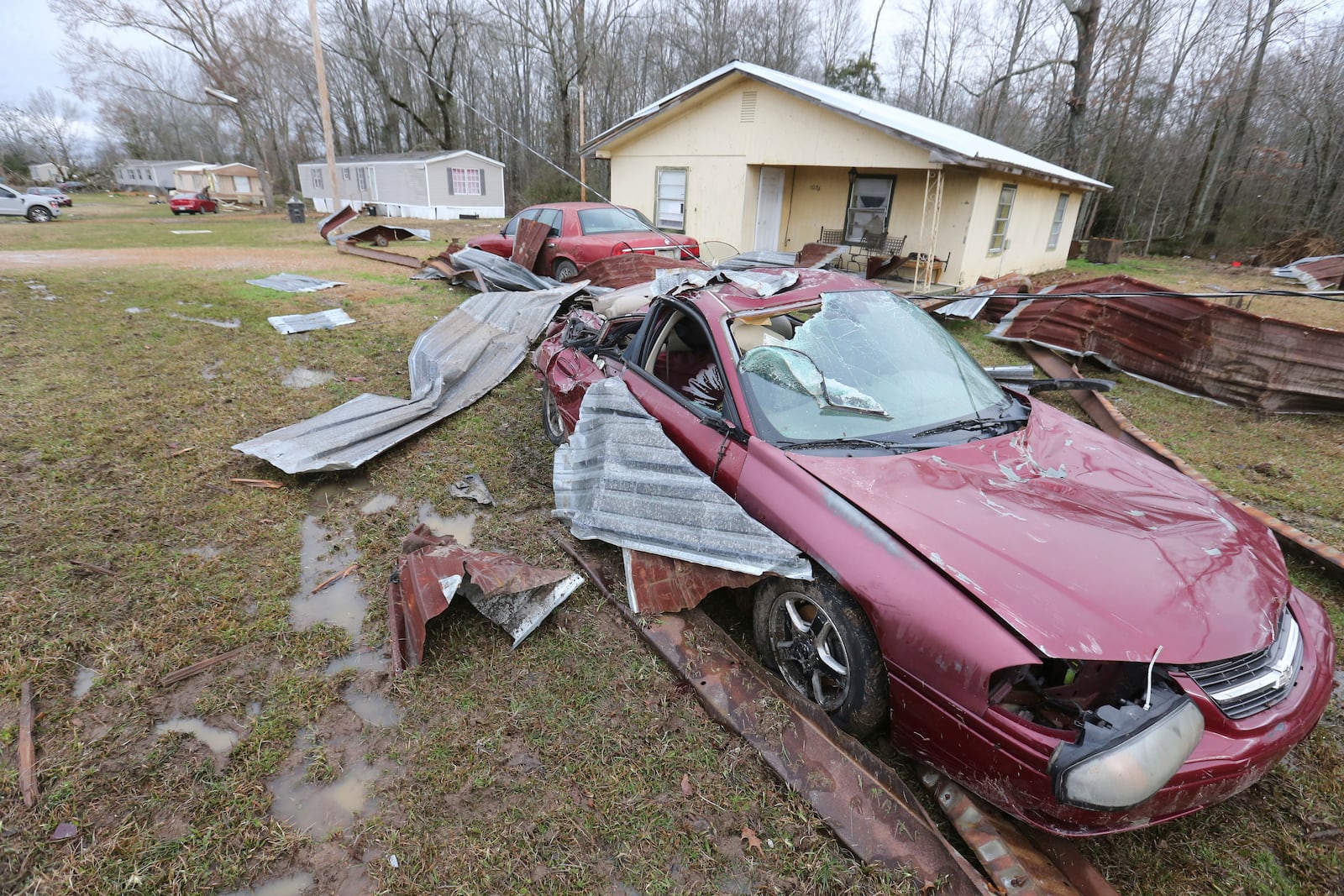 A car sits destroyed along the road in Shannon, Miss., Sunday, Feb. 16, 2025, following Saturday nights storms that passed through Northeast Mississippi. (Thomas Wells/Northeast Mississippi Daily Journal via AP)