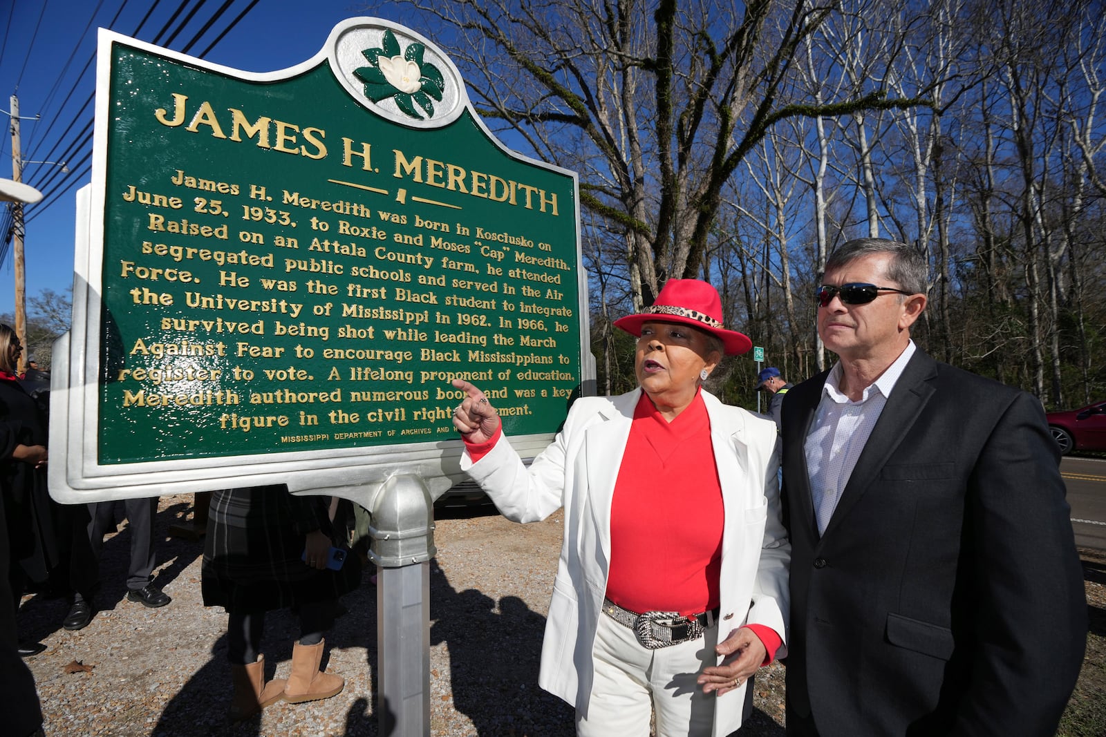 Judy Alsobrooks Meredith, wife of James Meredith, who became the first Black student to enroll at the University of Mississippi in 1962, left, and Kosciusko Mayor Tim Kyle, review the Mississippi Department of Archives and History marker recognizing Meredith's birthplace and his legacy in Kosciusko, Miss., Friday, Dec. 20, 2024. (AP Photo/Rogelio V. Solis)