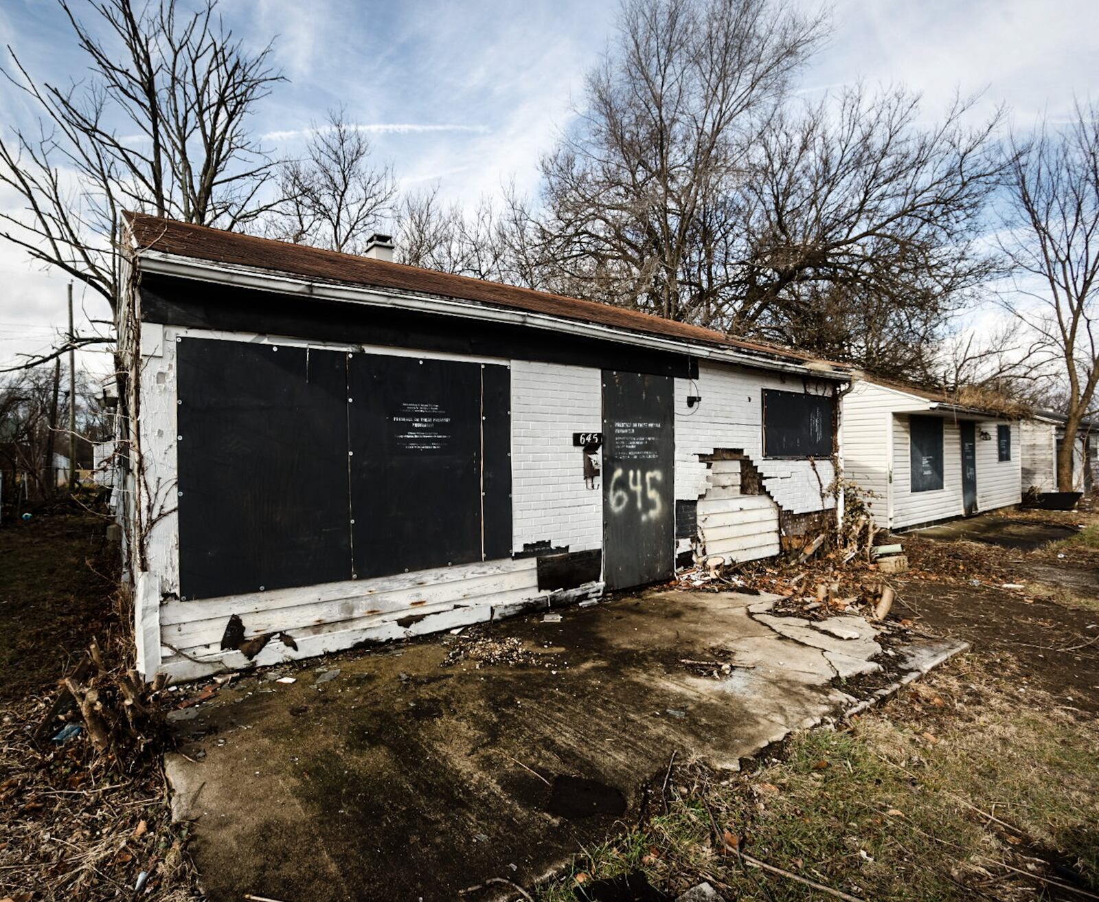 The city of Dayton plans to spend $22 million to remove more than 1,000 nuisance properties in the next several years. These vacant properties are on Mia Avevenue in Dayton. JIM NOELKER/STAFF