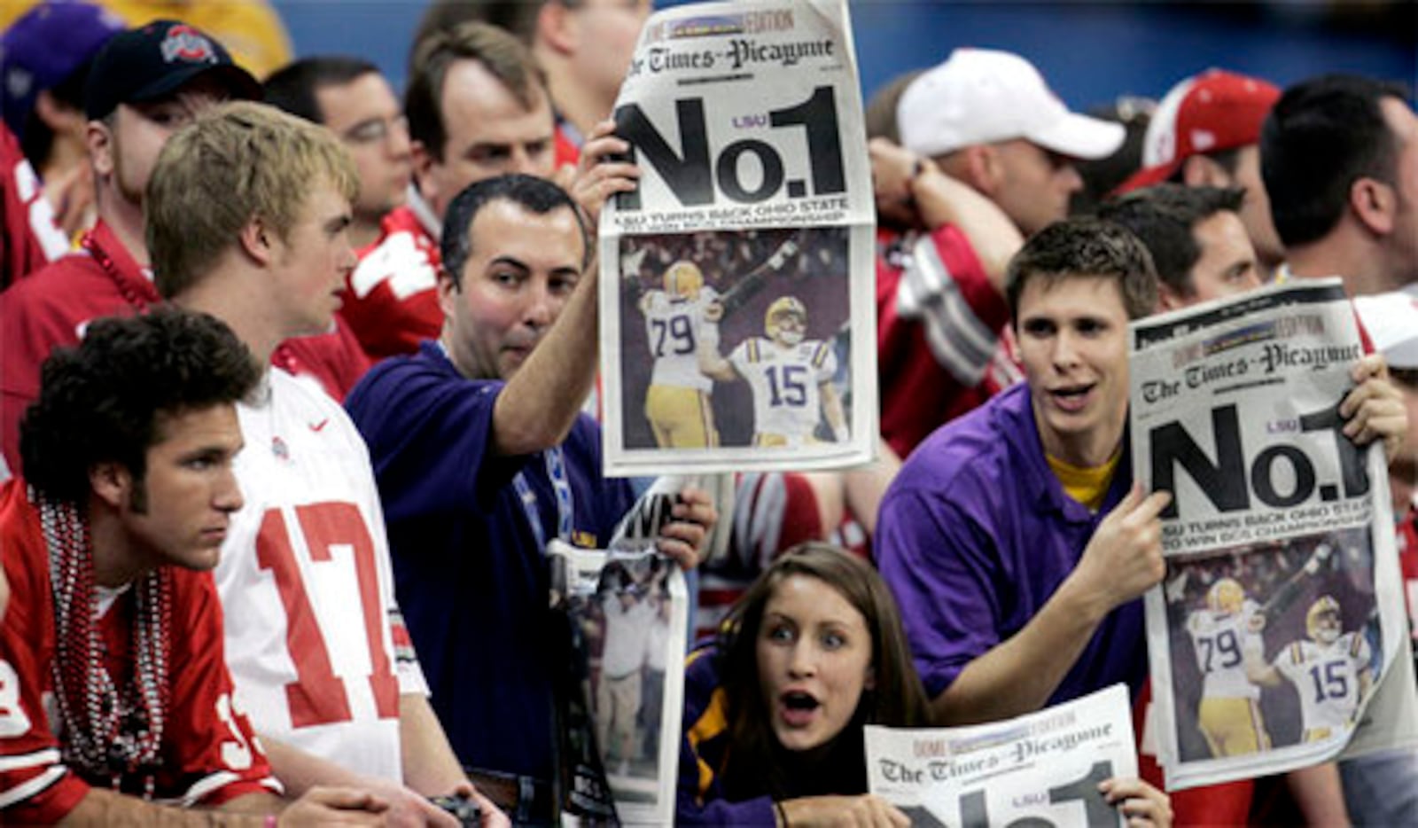 LSU fans show a special edition of a newspaper to Ohio State fans at the end of the BCS championship college football game at the Louisiana Superdome in New Orleans, Monday, Jan. 7, 2008. LSU defeated Ohio State 38-24 to win the national championship.