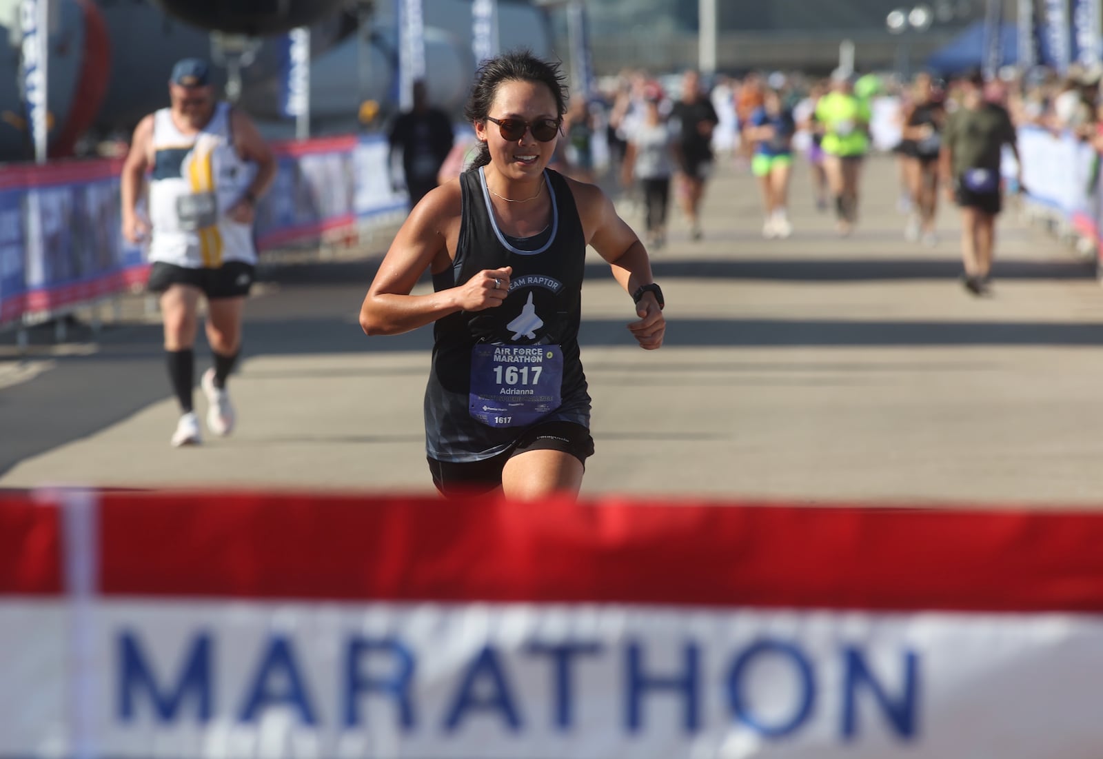 Adrianna Dong crosses the finish line as the first female finisher at the Air Force Marathon on Saturday, Sept. 21, 2024, at Wright-Patterson Air Force Base. David Jablonski/Staff