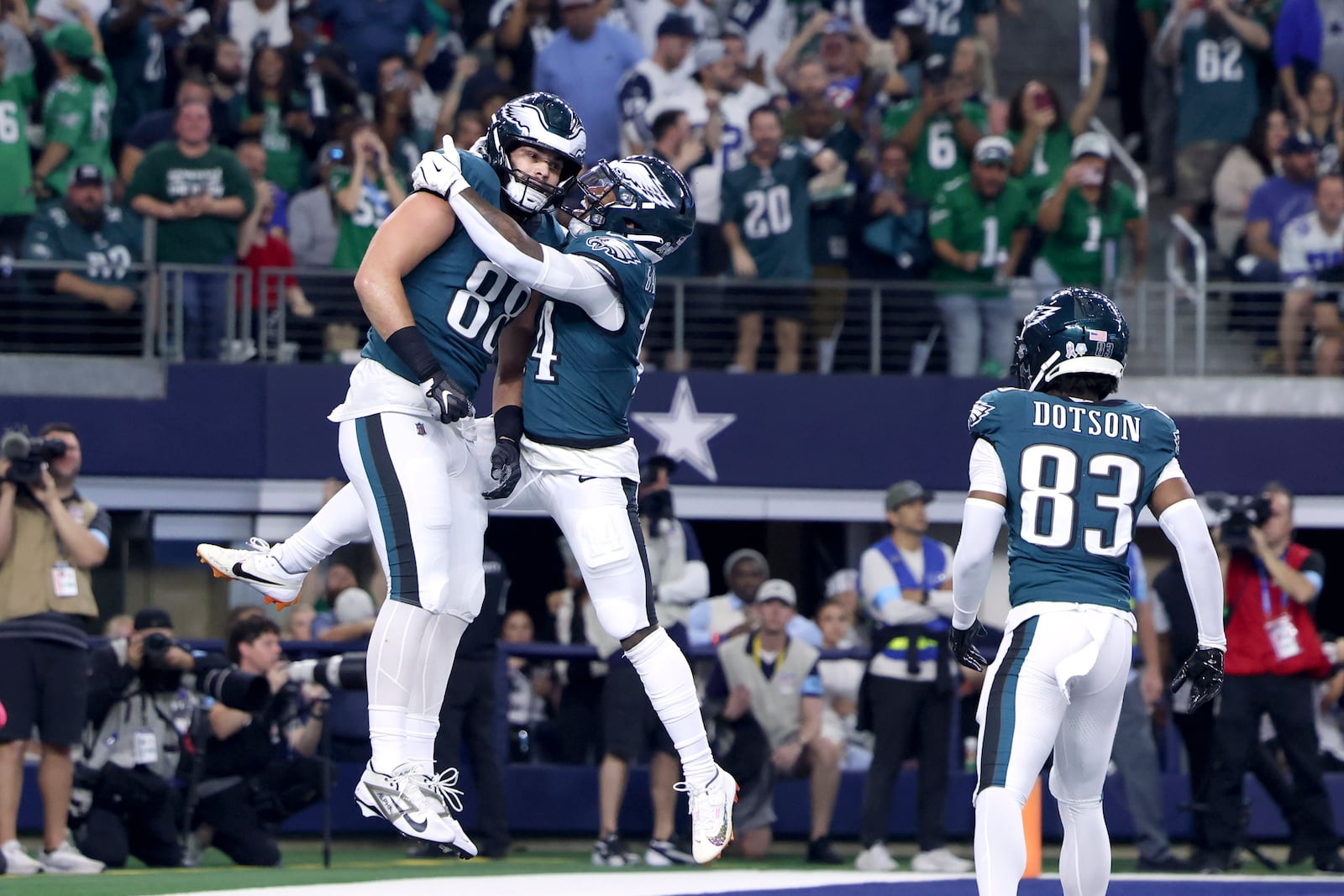 Philadelphia Eagles' Dallas Goedert (88), Kenneth Gainwell, center, and Jahan Dotson (83) celebrate a touchdown catch by Goedert in the first half of an NFL football game against the Dallas Cowboys in Arlington, Texas, Sunday, Nov. 10, 2024. (AP Photo/Gareth Patterson)