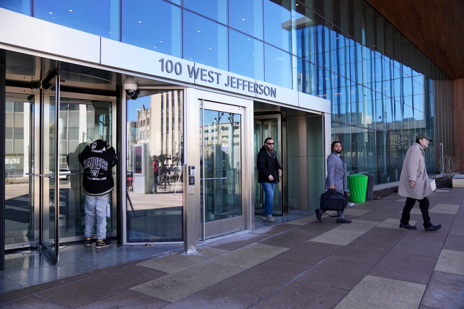 People enter and exit Will County Courthouse, where Joseph Czuba, 73, is charged with and on trial in the fatal stabbing of six-year-old Palestinian boy Wadee Alfayoumi and the wounding of his mother Hanan Shaheen, Tuesday, Feb. 25, 2025, in Joliet, Ill. (AP Photo/Erin Hooley)