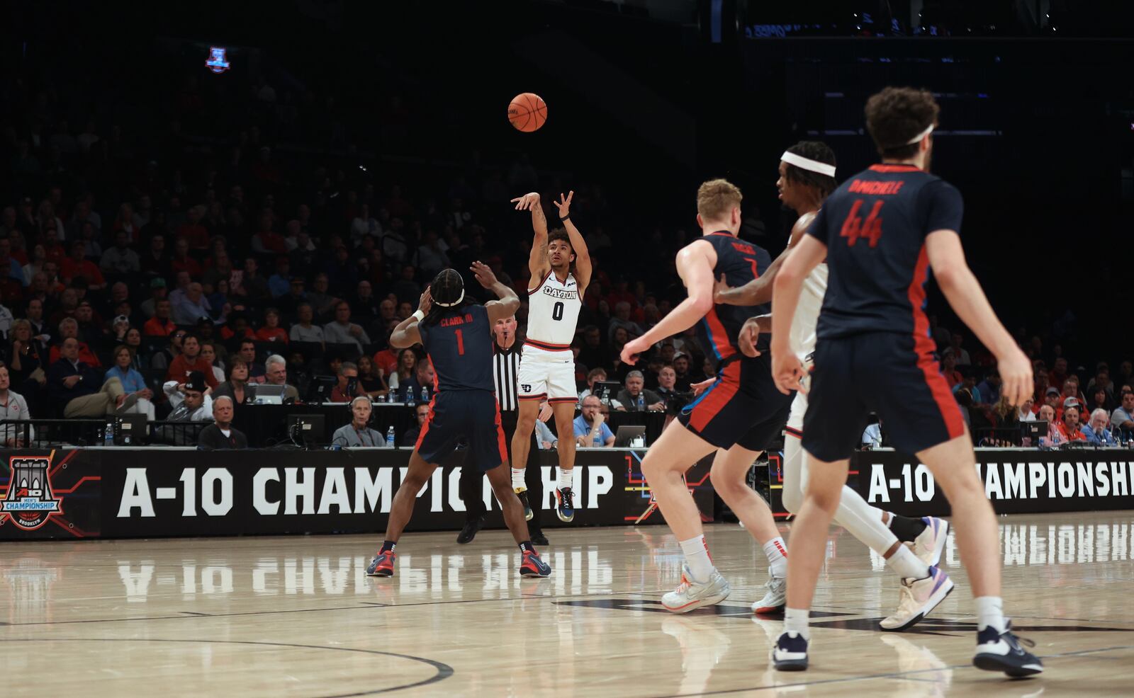 Dayton's Javon Bennett makes a 3-pointer in the final minute of the first half against Duquesne in the quarterfinals of the Atlantic 10 Conference tournament on Thursday, March 14, 2024, at the Barclays Center in Brooklyn, N.Y. David Jablonski/Staff