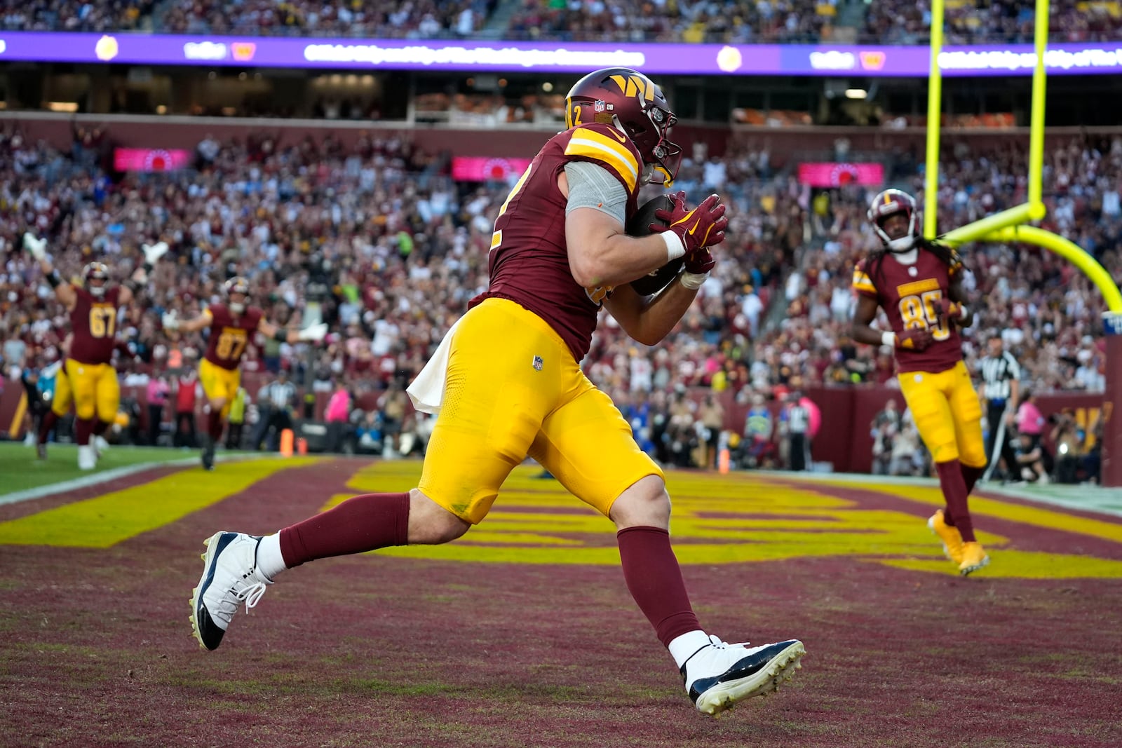 Washington Commanders tight end Ben Sinnott catches a 3-yard touchdown pass during the second half of an NFL football game against the Carolina Panthers, Sunday, Oct. 20, 2024, in Landover, Md. (AP Photo/Stephanie Scarbrough)