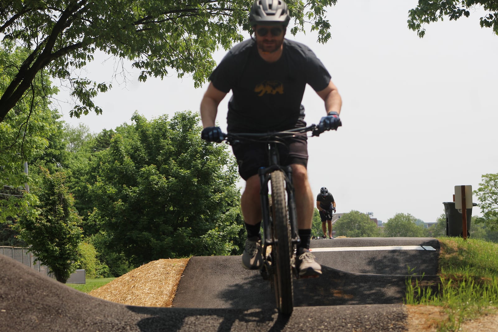 Dan McIntyre, 42, of Middletown, and Brandon Botschner, 39, of Oakwood, ride the tracks at the Dayton Bike Yard on May 18, 2023. CORNELIUS FROLIK / STAFF