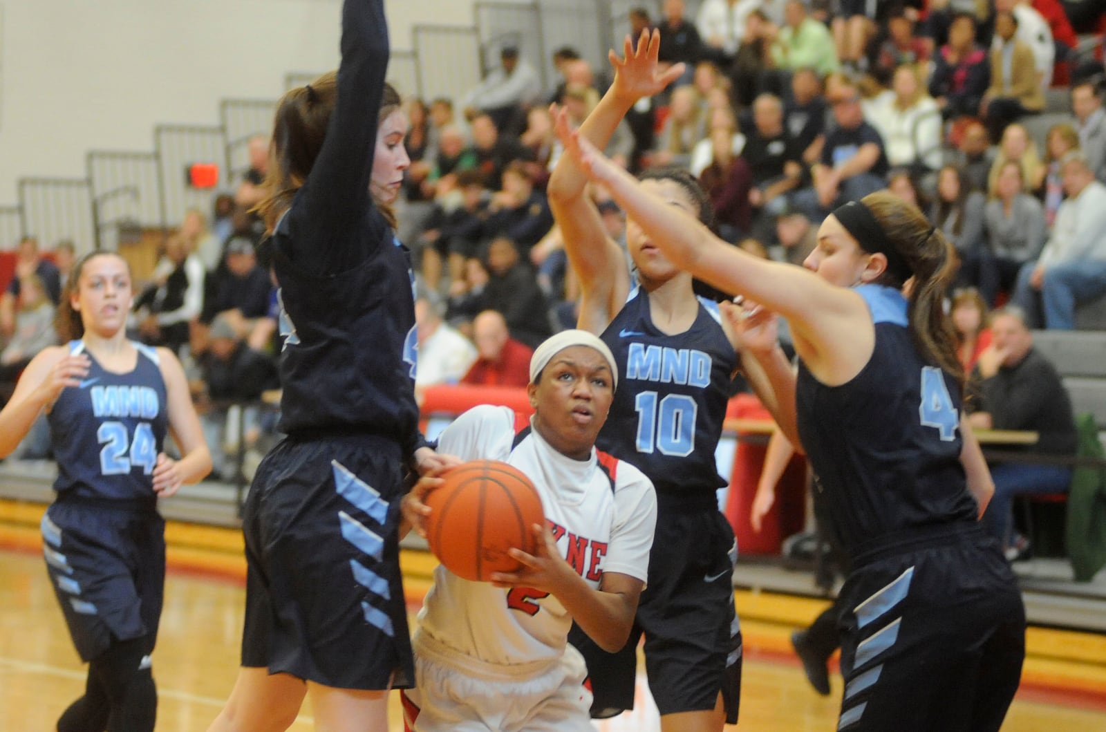 Nyla Hampton of Wayne (with ball) takes on three MND defenders. MARC PENDLETON / STAFF