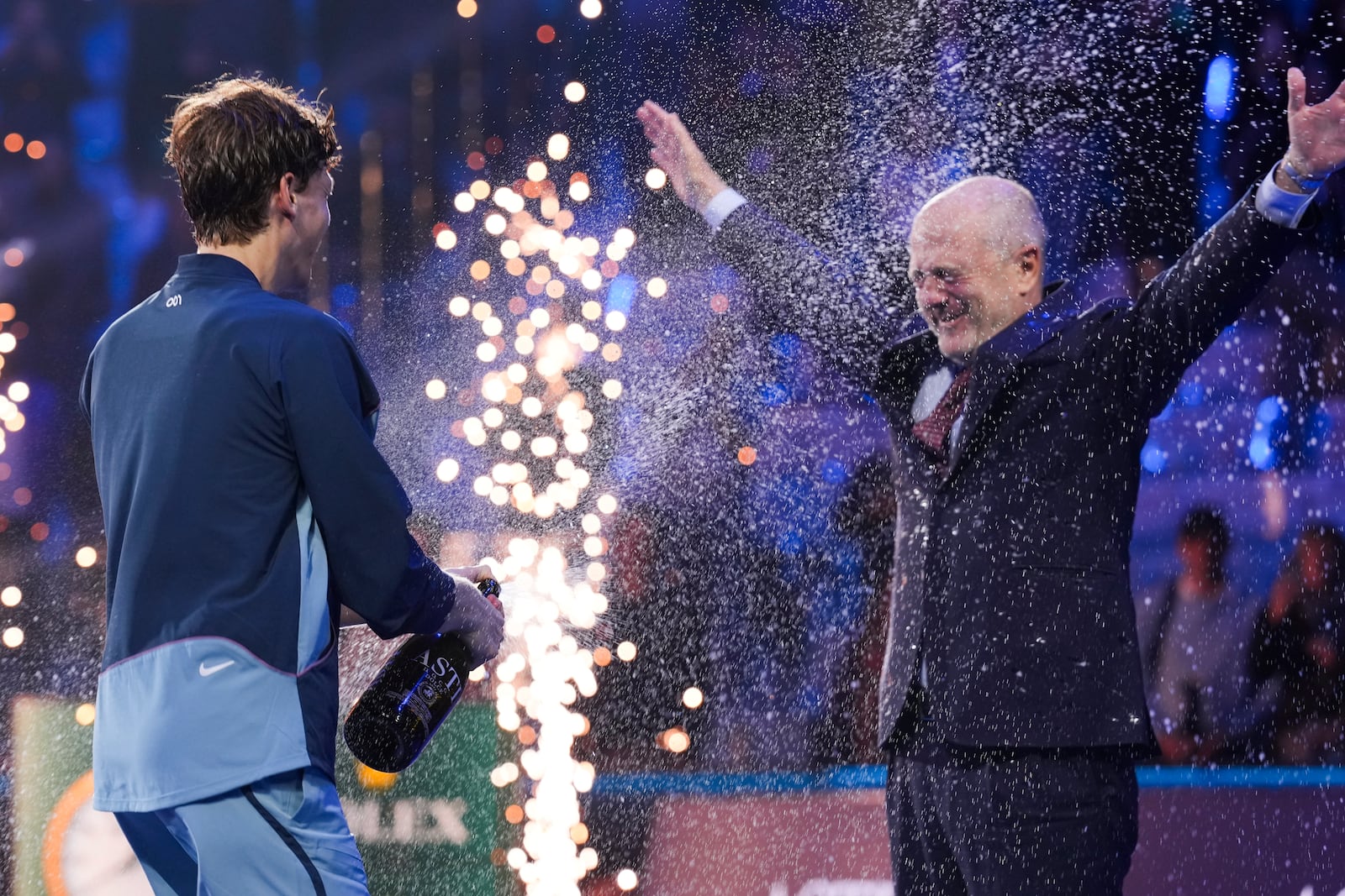 Italy's Jannik Sinner sprays Angelo Binaghi, the President of the Italian Tennis Federation, after winning the final match of the ATP World Tour Finals against Taylor Fritz of the United States at the Inalpi Arena, in Turin, Italy, Sunday, Nov. 17, 2024. (AP Photo/Antonio Calanni)