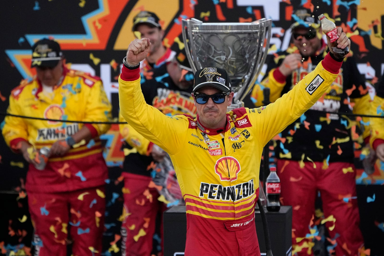 Joey Logano celebrates after winning a NASCAR Cup Series Championship auto race for the championship at Phoenix Raceway, Sunday, Nov. 10, 2024, in Avondale, Ariz. (AP Photo/John Locher)