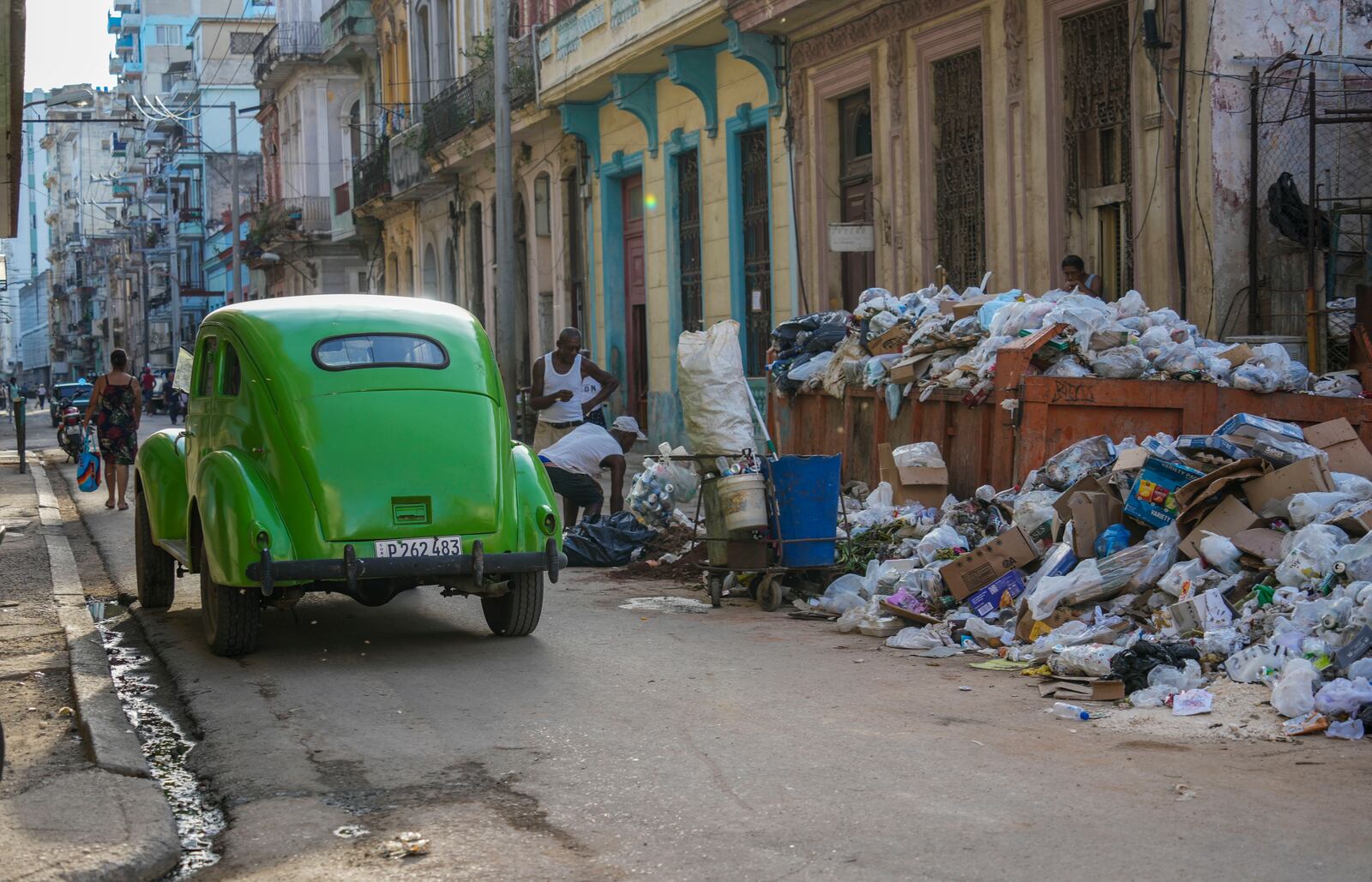 FILE - A classic American car drives past garbage in Havana, Cuba, Sept. 24, 2024. (AP Photo/Ramon Espinosa, File)