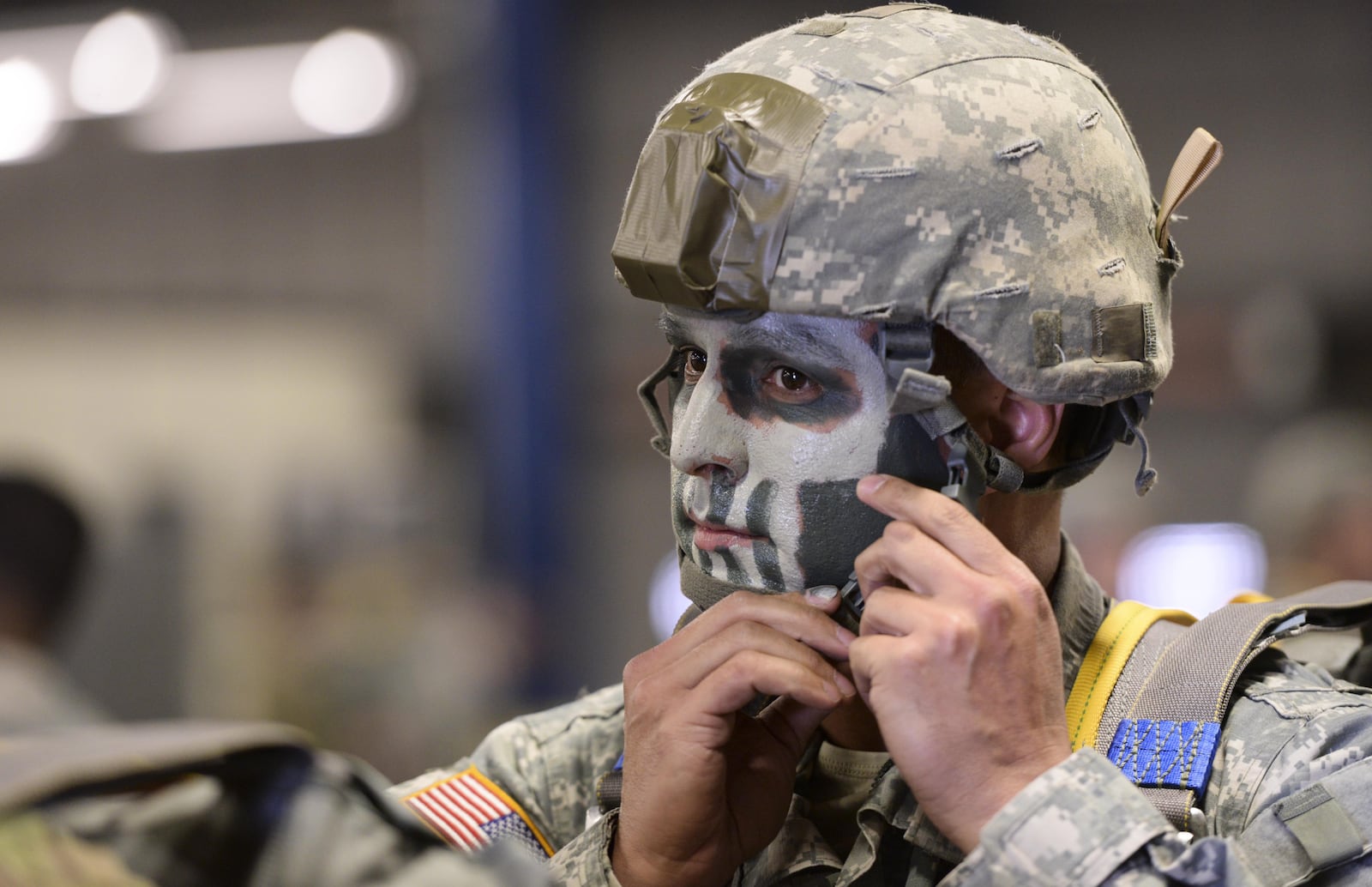 U.S. Army Reserve Capt. Phil Spence, 412th Civil Affairs Battalion civil military operations center chief, fastens his helmet strap prior to a static line jump over Wright-Patterson Air Force Base in March 2016. The 412th is an Army Reserve unit out of Columbus and is required to complete eight jumps per year to remain current. Army photo